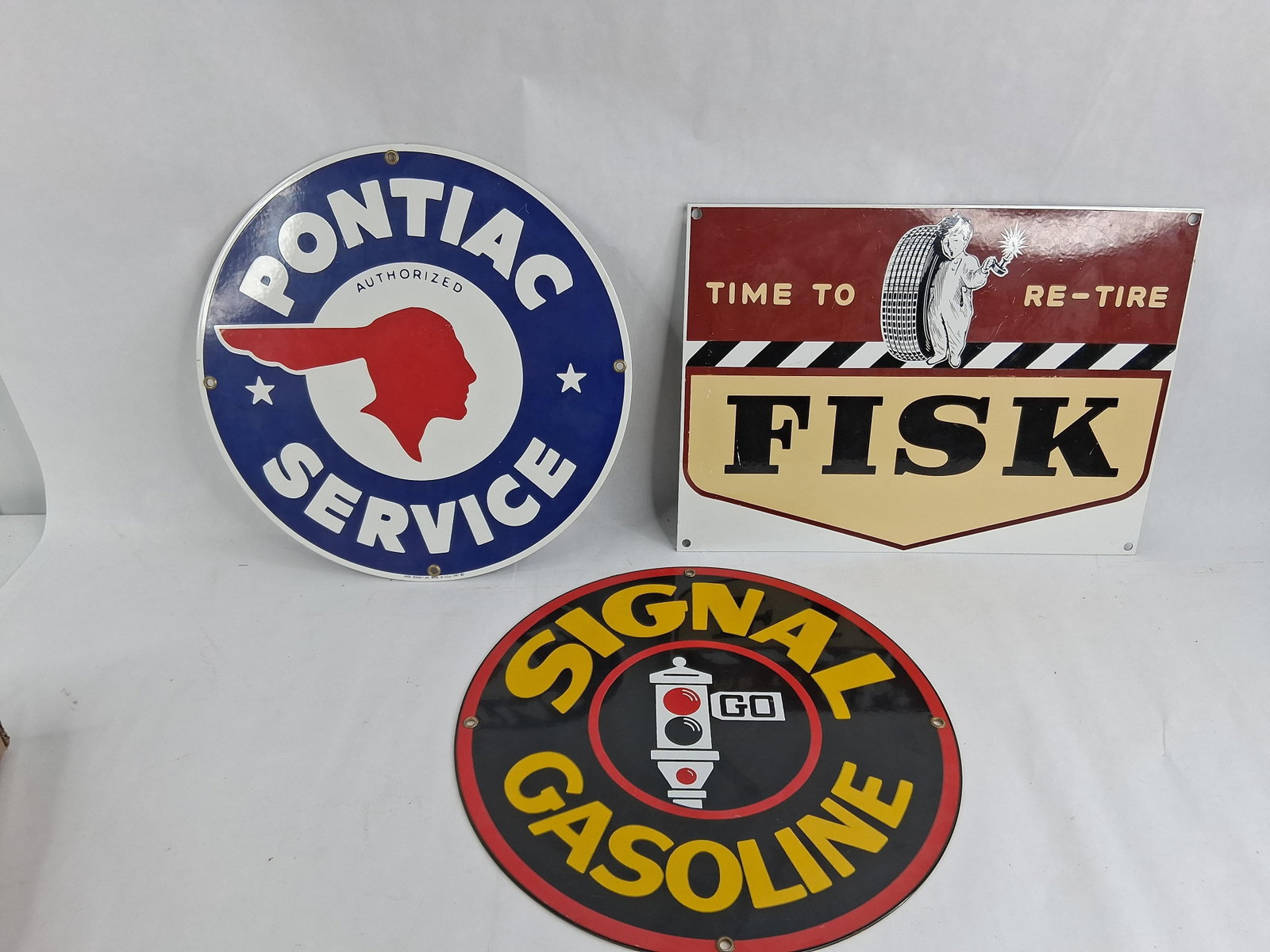 A Trio of Ande Rooney Licensed Advertising Signs: 11.25 dia and 13in long A collection of three contemporary single-sided porcelain enamel advertising signs manufactured by Ande Rooney Inc. This group features high-quality licensed reproductions of