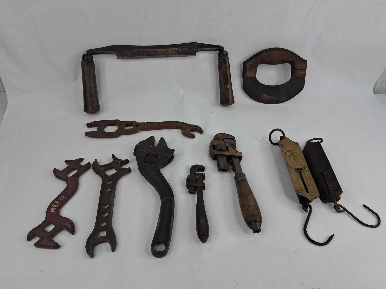 Antique & American Hand Tools & Hanging Scales: This group of antique and hand tools includes mechanical wrenches, hanging spring scales, and woodworking instruments. Identifiable markings include a 10-inch No. 80 Westcott adjustable wrench
