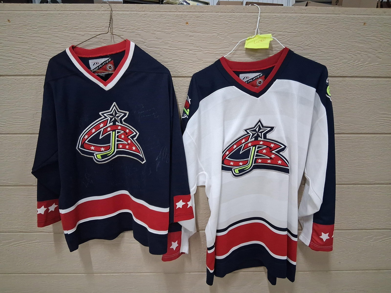 Pair Pro Player Blue Jackets Inaugural Jerseys: This lot comprises two replica ice hockey jerseys manufactured by Pro Player for the Columbus Blue Jackets, representing the franchise's inaugural logo era from approximately 2000 to 2003. Both