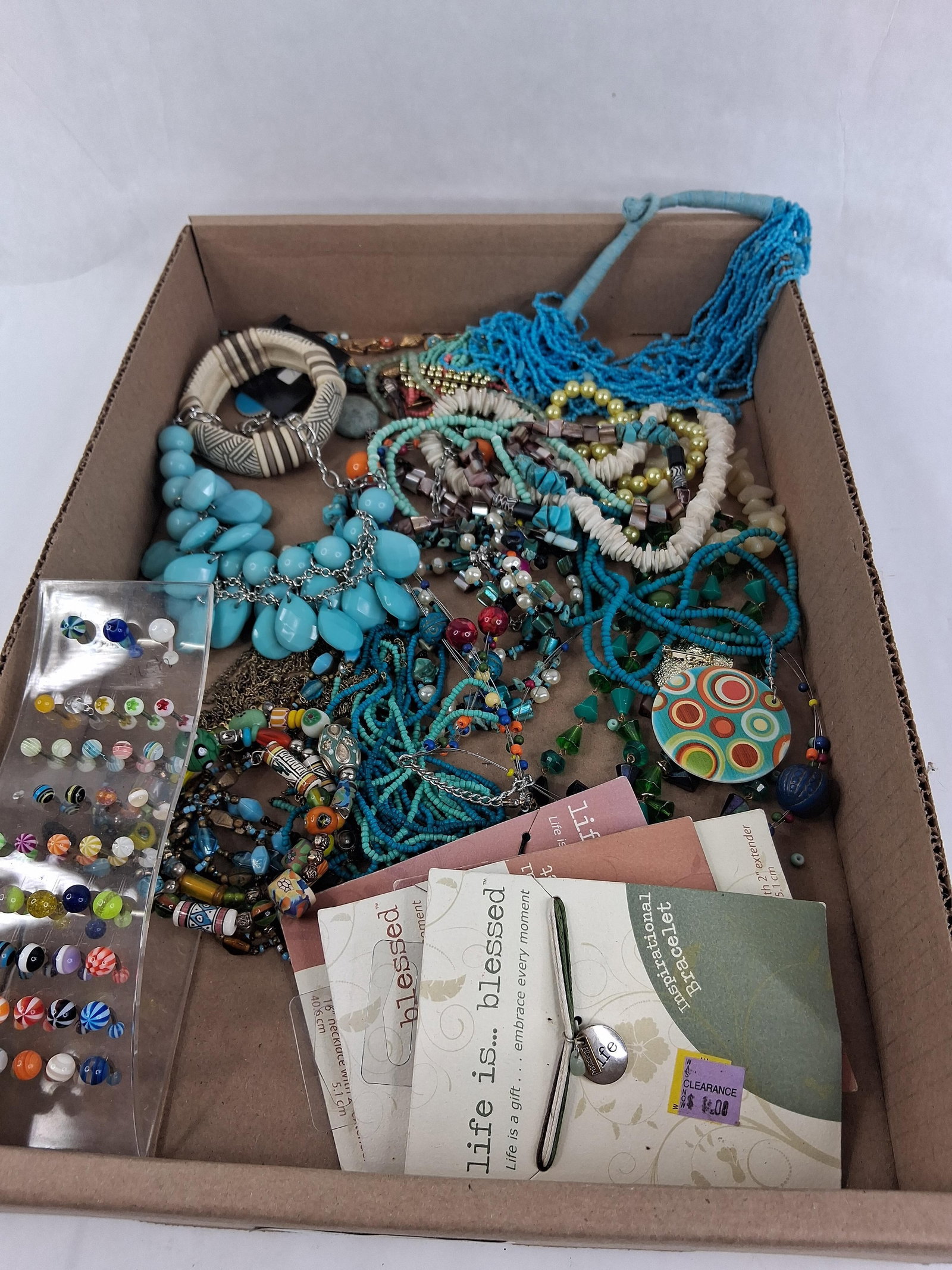 Life is Blessed Costume & Body Jewelry Collection: This lot contains an assortment of contemporary costume jewelry and body piercings. Featured in the collection are four carded items from the life is blessed brand, consisting of two inspirational bra