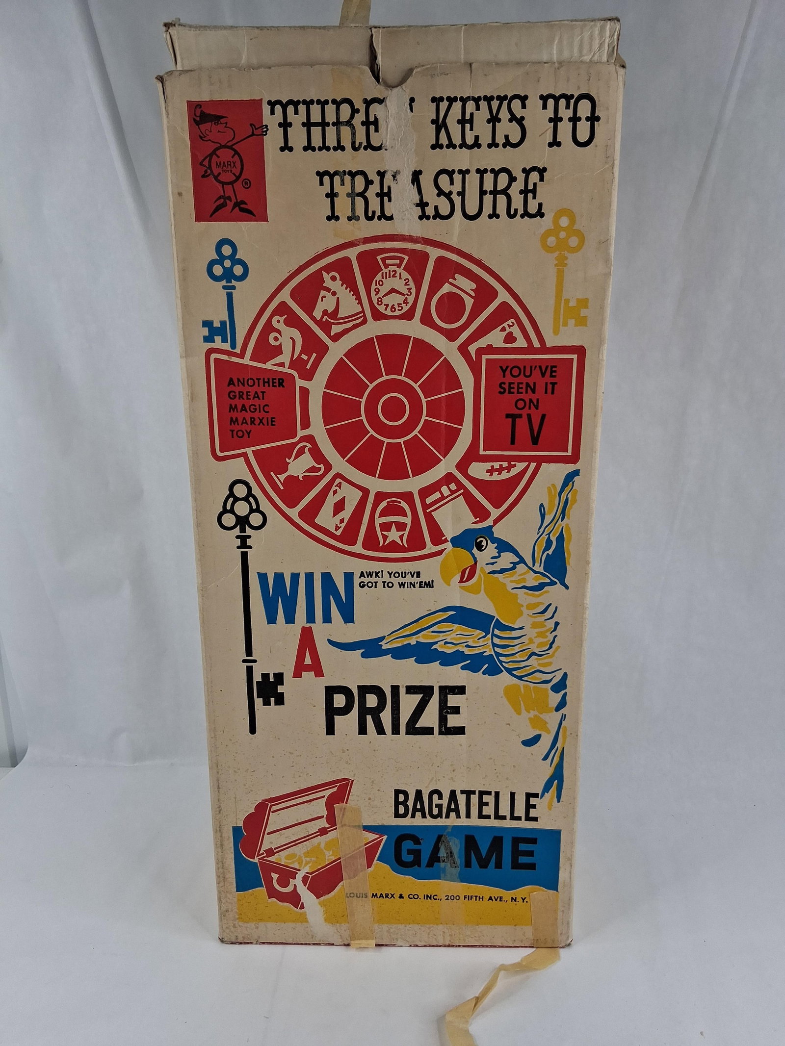 Louis Marx & Co. Three Keys to Treasure Bagatelle: This mid-century Three Keys to Treasure bagatelle is a pinball-style toy manufactured by Louis Marx and Company, Inc. The game is constructed with a clear plastic housing over a colorful,
