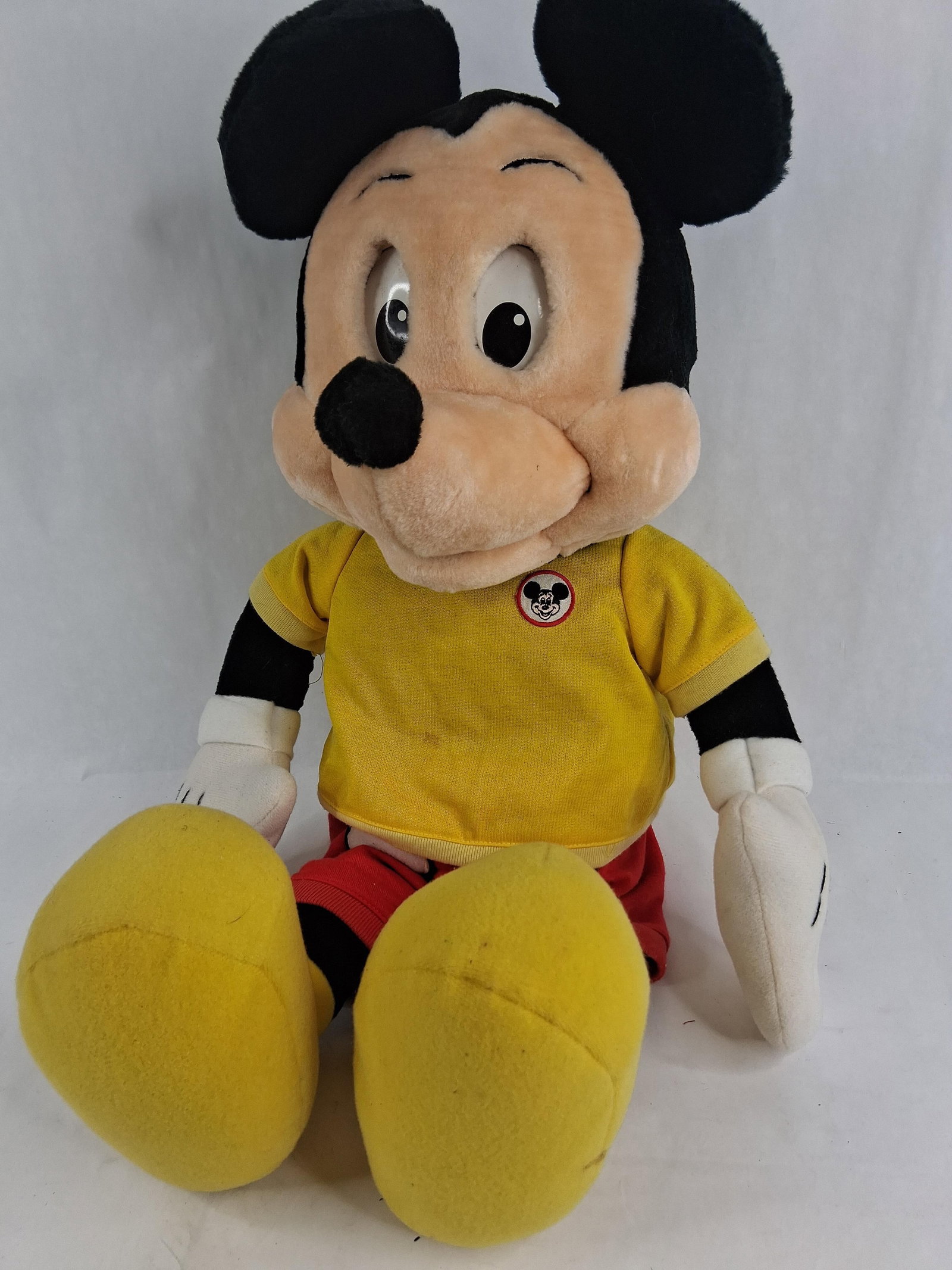 Worlds of Wonder Talking Mickey Mouse Plush Toy: This is an animatronic talking Mickey Mouse plush toy manufactured by Worlds of Wonder (WOW). The toy is constructed with a soft fabric plush body, plastic eyes, and a molded plastic nose. It is