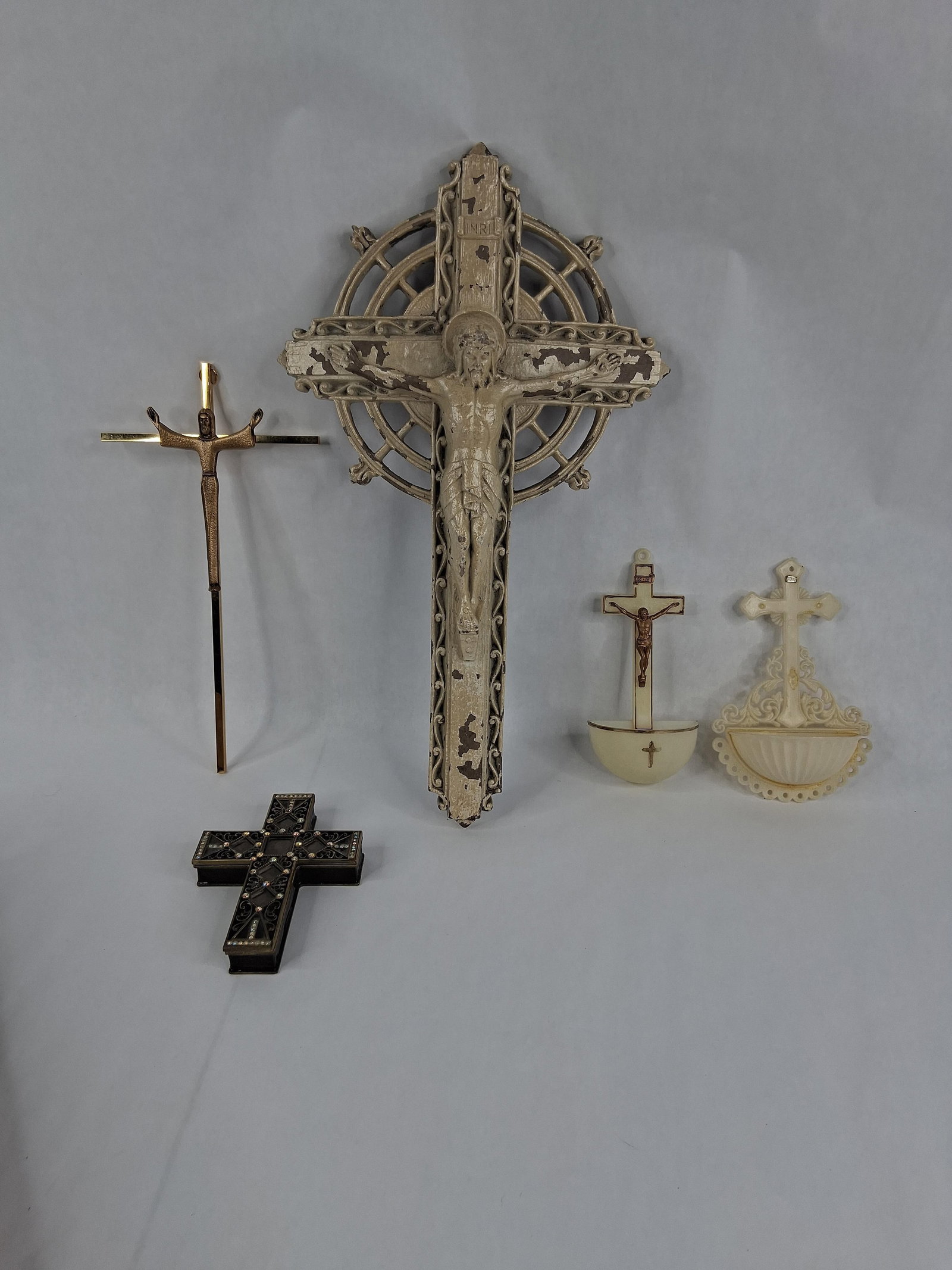 5 Religious Items w/ Pardon Cross & Nikky Box: largest is 14 in tall This collection consists of five religious objects including wall crucifixes, holy water fonts, and a decorative box. The primary item is a large ecclesiastical wall crucifix