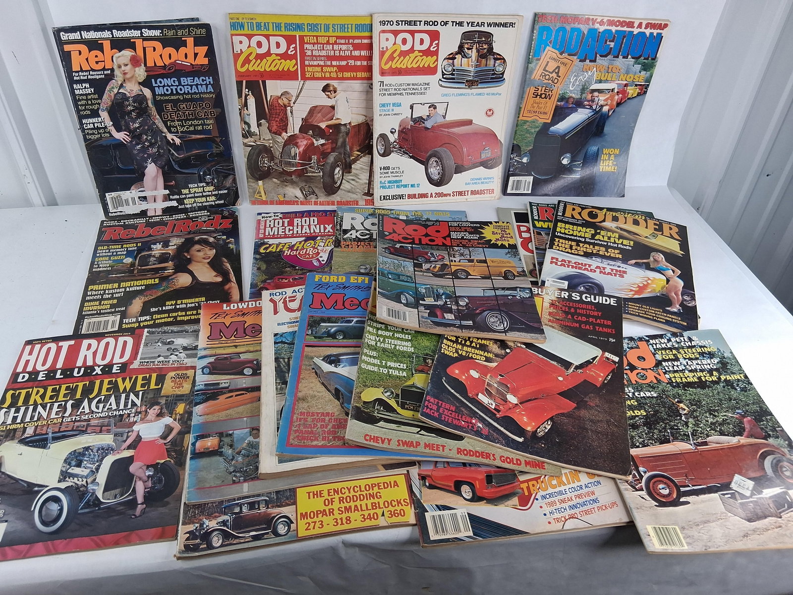 Hot Rod & Custom Car Magazines: This collection consists of approximately 19 automotive magazines and one loose centerfold poster, primarily focusing on hot rod and custom car culture from the 1970s through 2014. The assortment