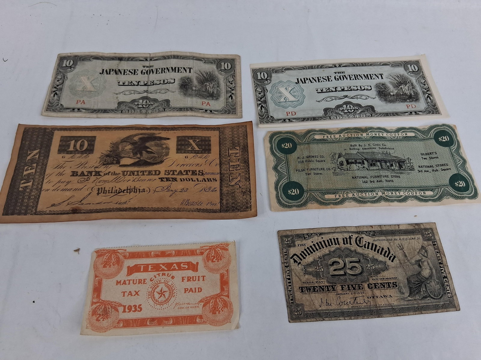 Banknotes & Ephemera: WWII Japanese & 1900 Canada: A collection of banknotes and historical paper ephemera from various regions and periods. The group contains two WWII-era Japanese Government occupation notes for the Philippines denominated in ten