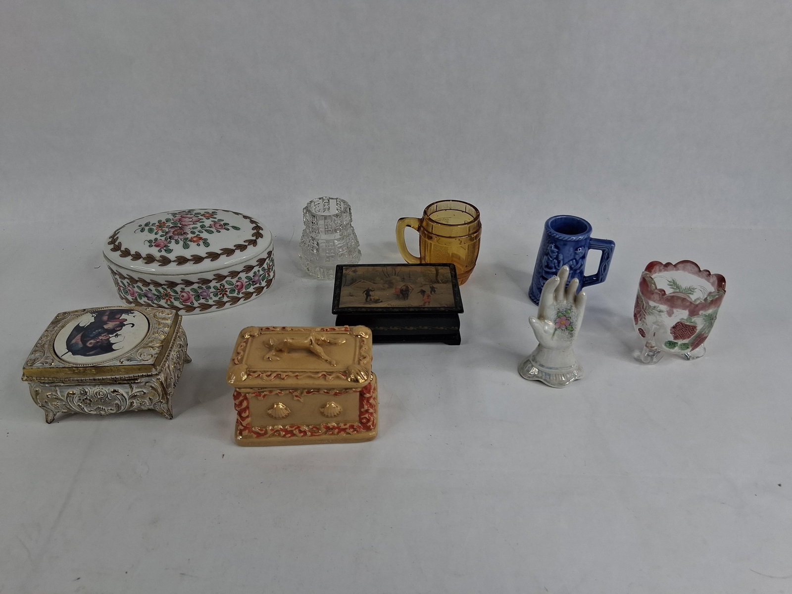 J.P.T. Paris & Fedoskino Lidded Boxes & Items: This collection consists of several decorative items, including lidded boxes, glassware, and figurines. A large oval porcelain box by J.P.T. Paris features hand-painted floral sprays and a