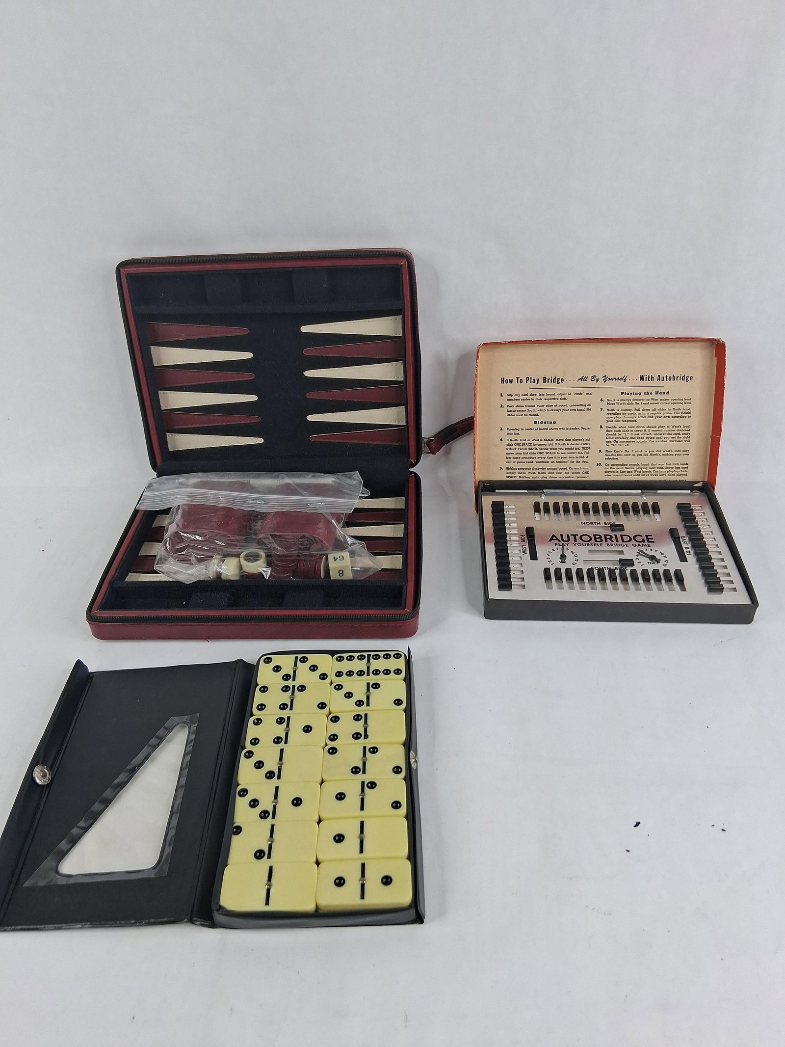 3 Table Games w/ Autobridge Pocket Model PA: This lot contains three table games. The first is an Autobridge solitaire bridge game, specifically the Deluxe Pocket Model No. PA, produced by The Autobridge Co. of New York, N.Y. The set includes a