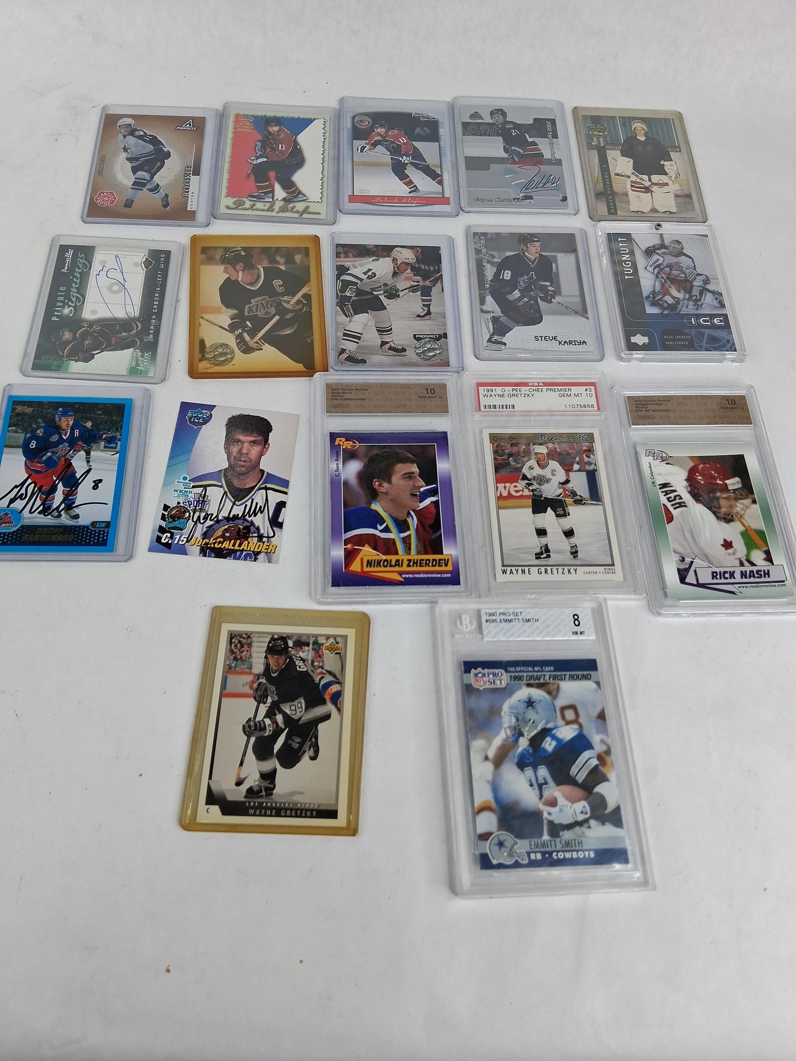 17 Sports Cards w/ Graded Gretzky & Smith Rookies: This collection consists of 17 sports trading cards, featuring prominent figures in professional hockey and football. The lot includes professionally graded high-grade cards, authenticated