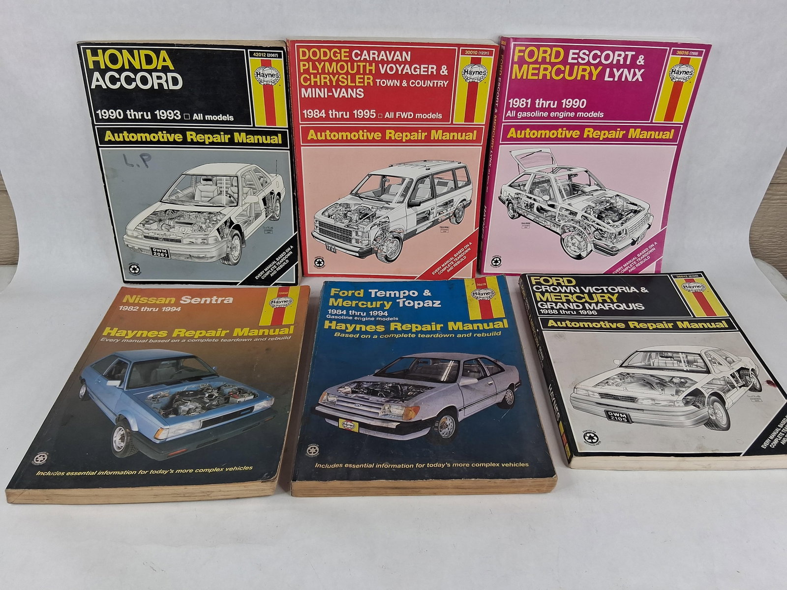 6 Haynes Repair Manuals: Ford, Mercury & Chrysler: This collection consists of six Haynes automotive repair manuals published by Haynes North America, Inc. The manuals cover a variety of domestic and import vehicles from the 1980s and 1990s. Each volu