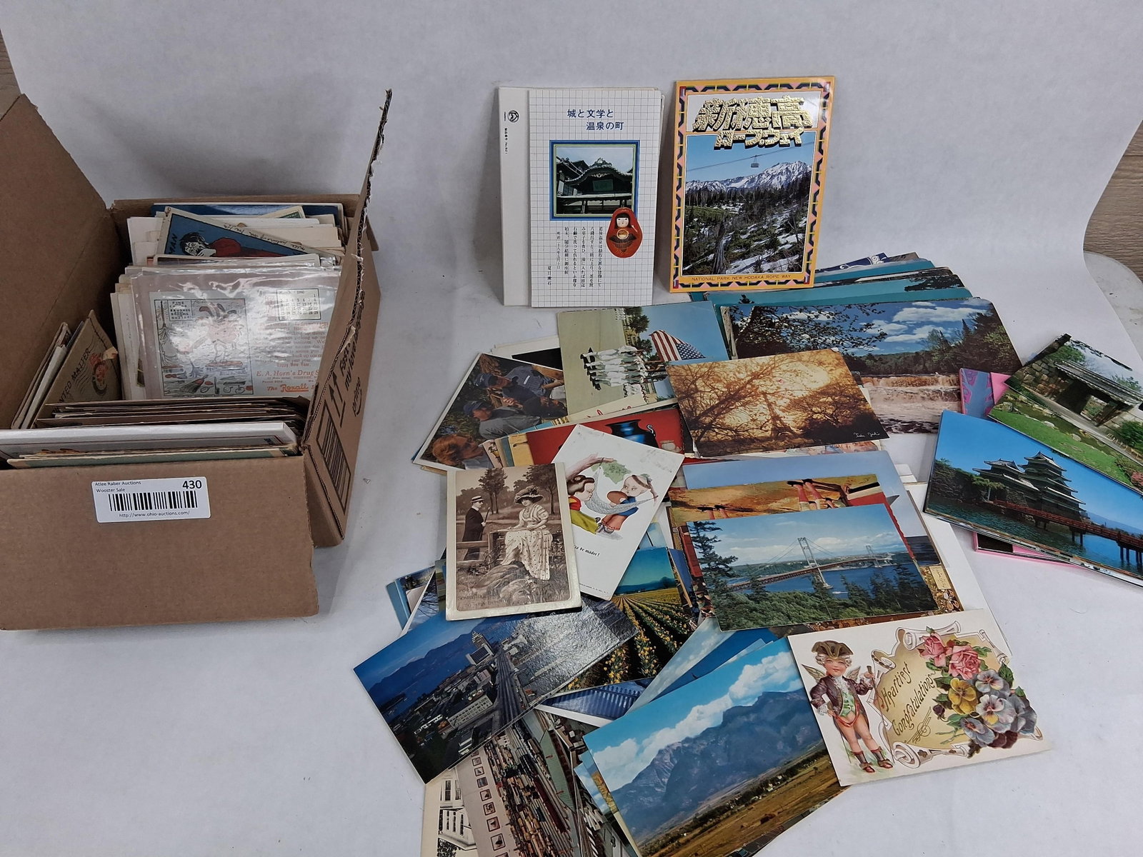& Modern Postcards & Paper Ephemera: This lot features a large collection of postcards and related paper ephemera spanning the early 20th century through the 1980s. The assortment is housed in a single cardboard box and includes holiday