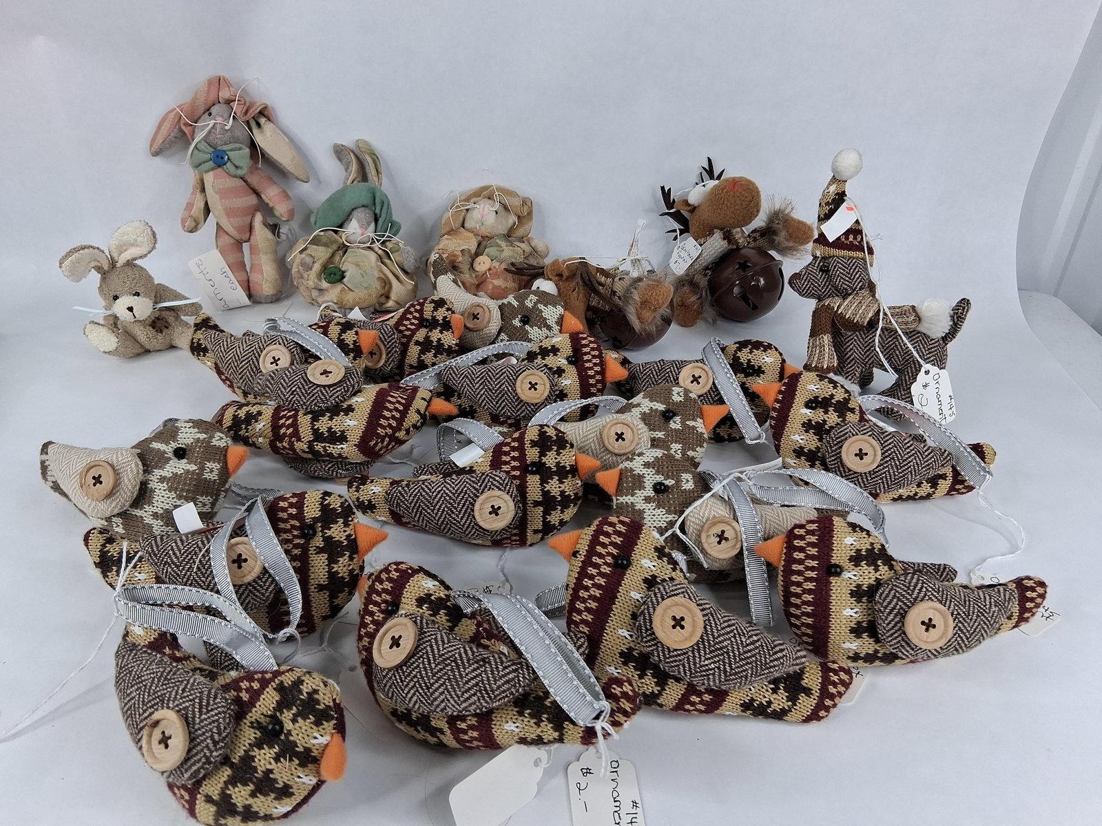 Country-Style Fabric & Knit Ornaments & Figurines: A collection of decorative textile ornaments and figurines crafted in a contemporary country or primitive folk art style. The assortment includes a group of stylized birds constructed from brown,