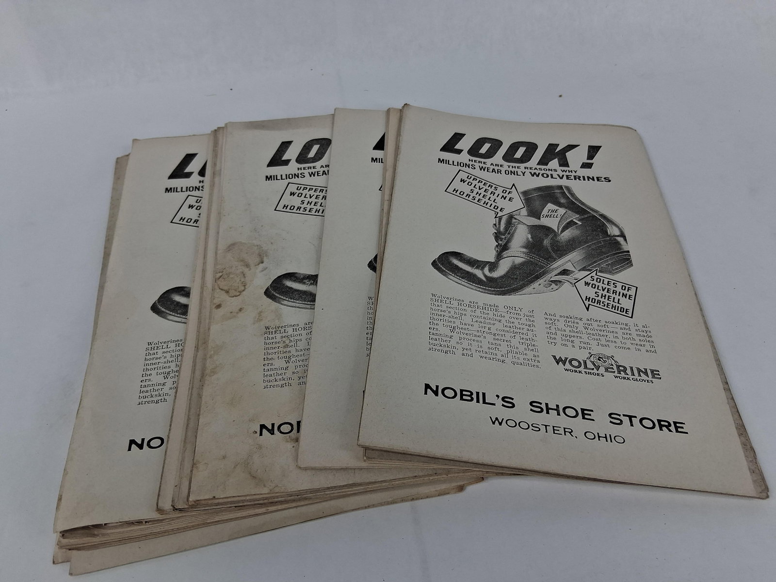 Wolverine Shell Horsehide Work Shoe Handbills: A collection of printed advertising handbills for Wolverine Shell Horsehide work shoes and work gloves, specifically branded for Nobil's Shoe Store in Wooster, Ohio. These single-sided paper flyers