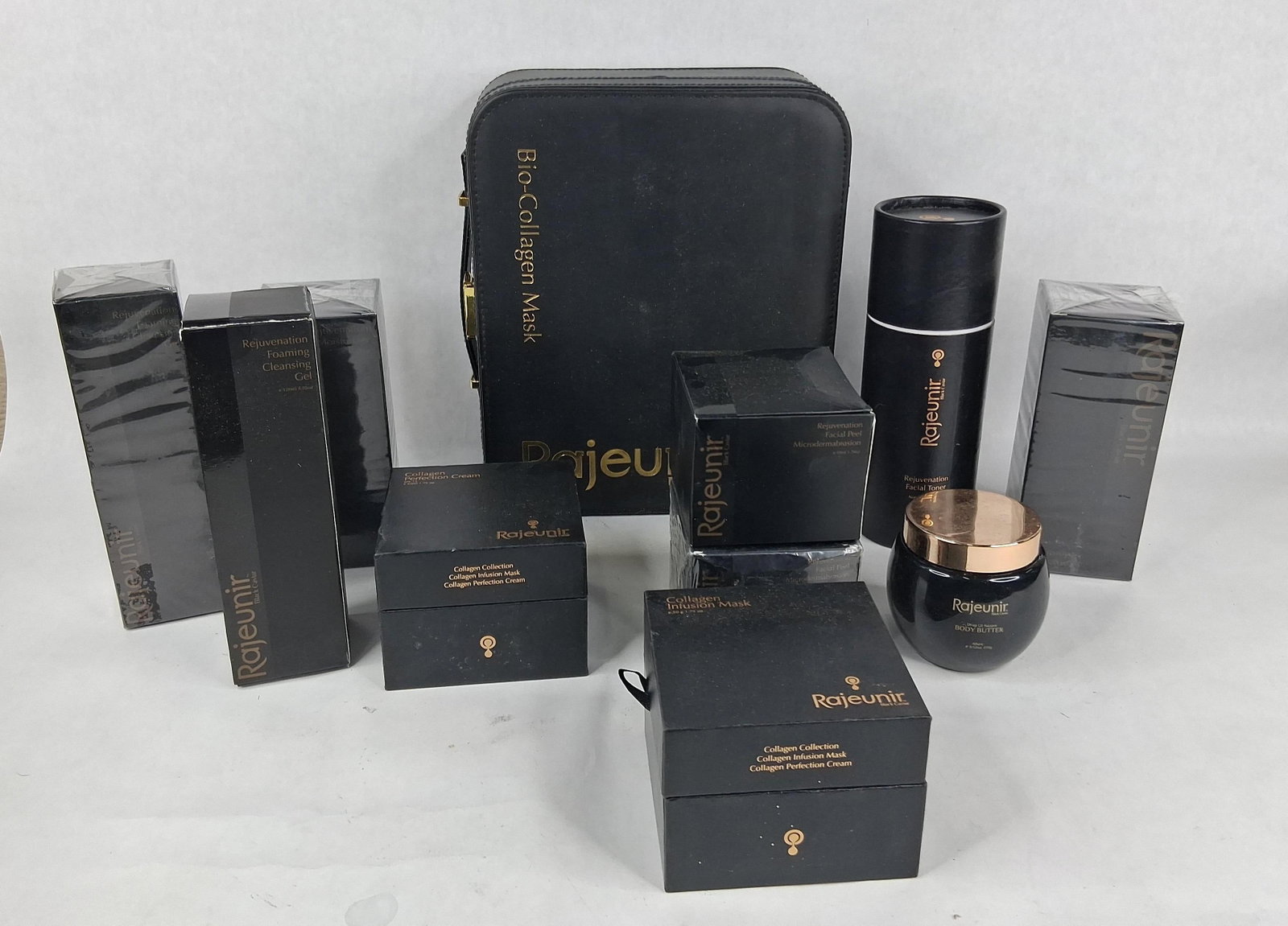 Rajeunir Black Caviar Skincare Products: This collection features a variety of premium skincare products from the Rajeunir Black Caviar line. The assortment includes a Bio-Collagen Mask Set housed in a black vanity travel case with an