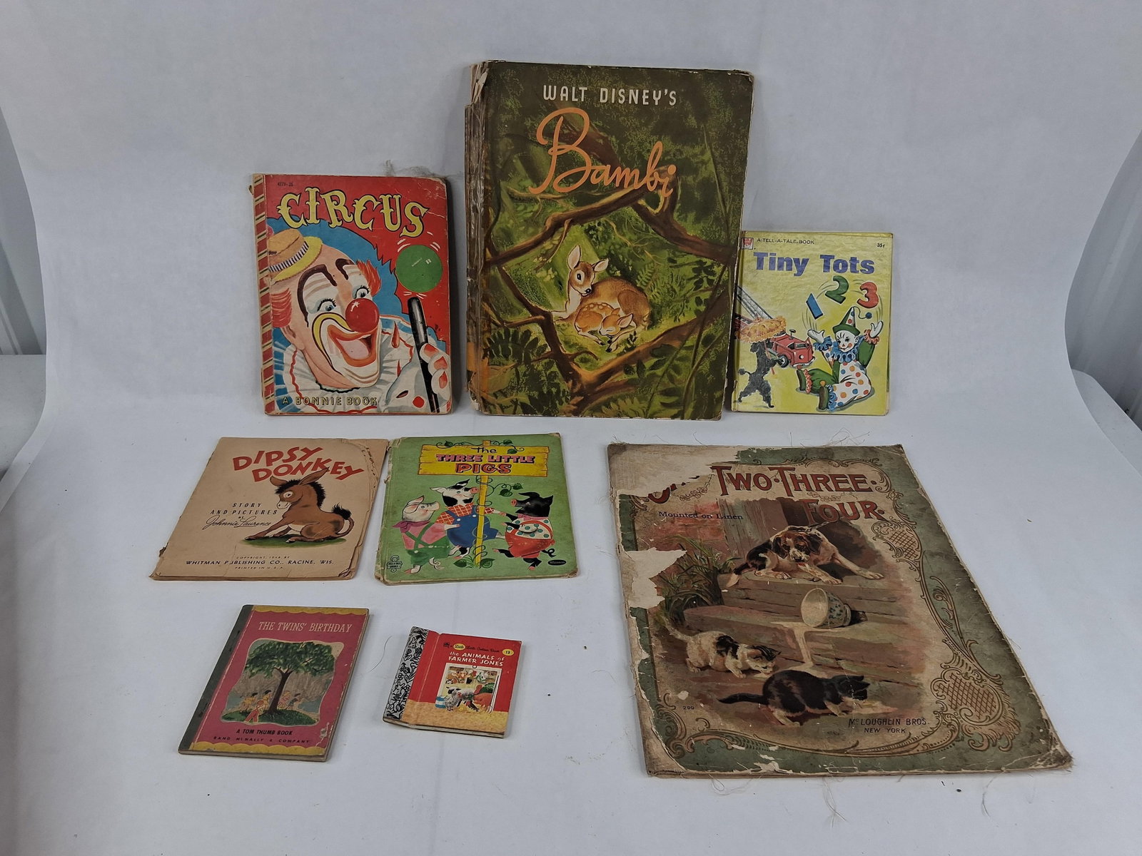 Set Children's Books, Disney's Bambi 1941: This assortment of mid-20th-century children's literature features various formats including pictorial hardcovers, softcovers, linen-mounted volumes, and miniature editions. A primary highlight is a l