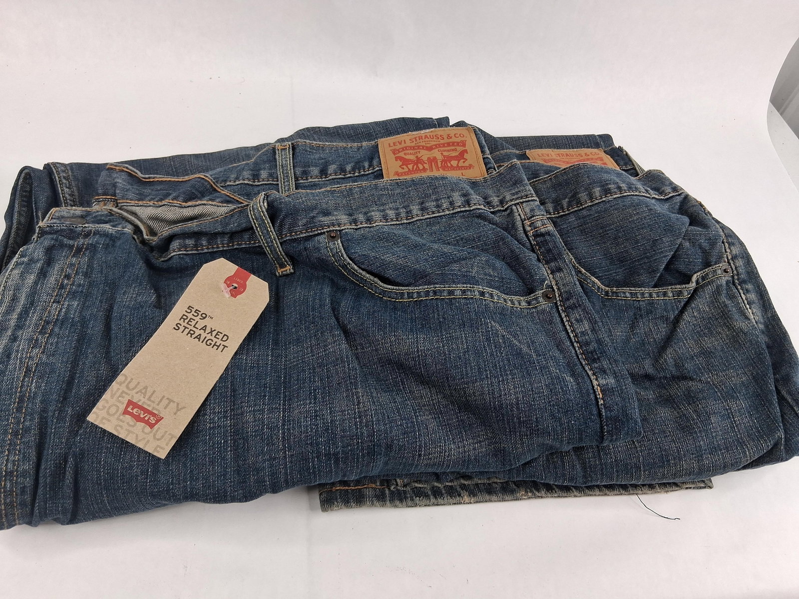 Pair Levi Strauss & Co. 559 Relaxed Straight Jeans: This lot consists of two pairs of Levi Strauss and Co. 559 Relaxed Straight denim jeans. These garments are constructed from blue denim in a medium wash featuring subtle fading and whiskering. The