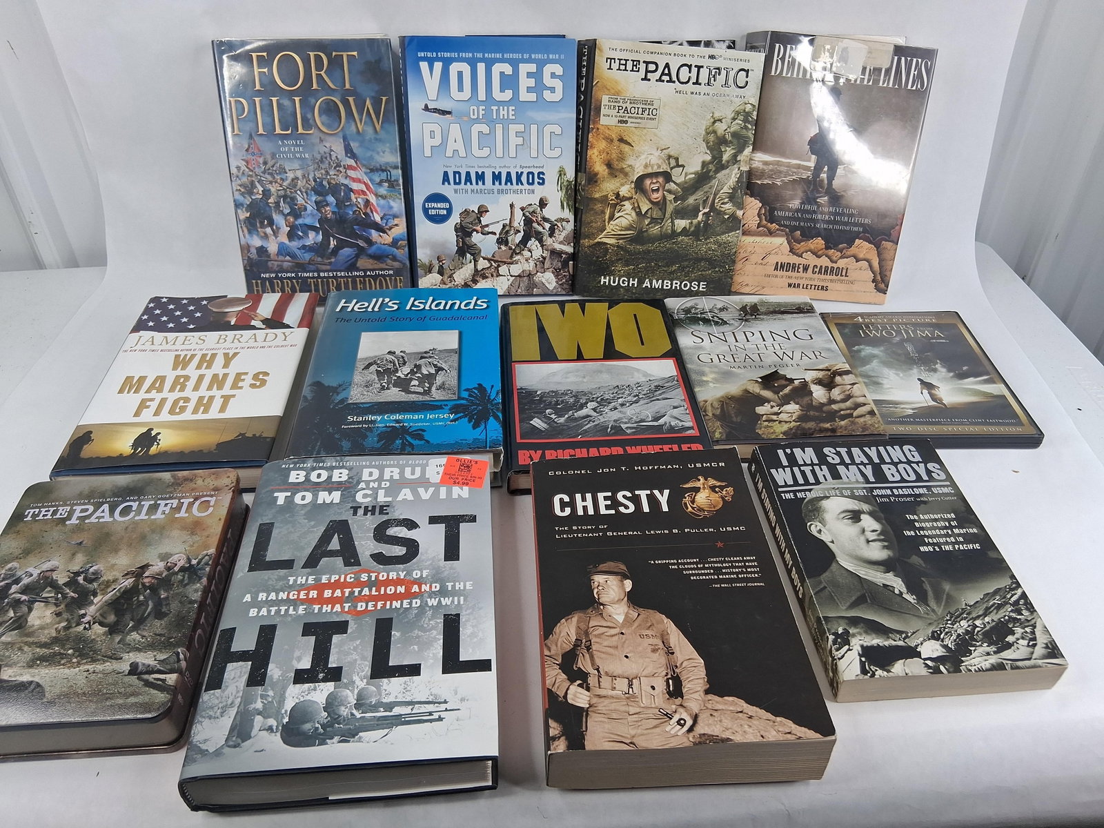 USMC & WWII Military History Books & Media (DJ): This assortment focuses on military history with a primary emphasis on the United States Marine Corps (USMC) and World War II. The collection includes various hardcover volumes with dust jackets and