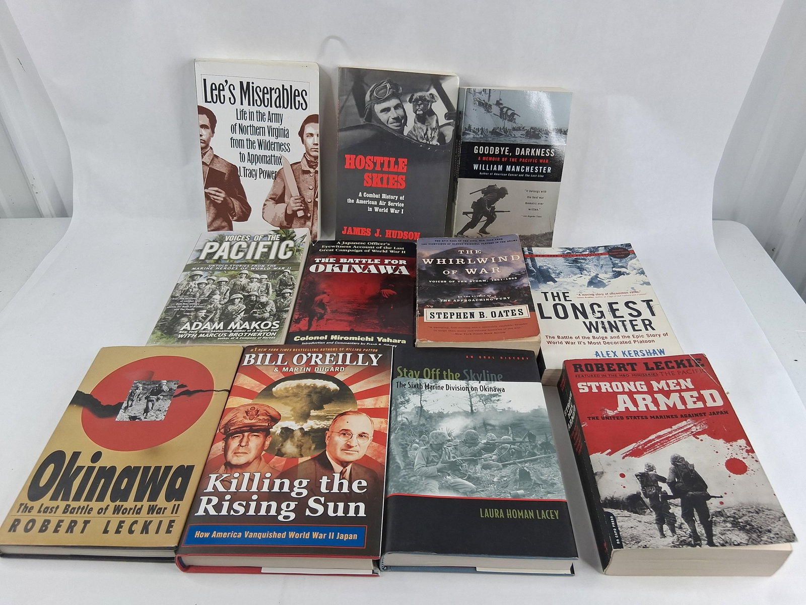 Pacific Theater & US Military History Books w/ DJ: This lot features a collection of eleven volumes primarily documenting military history, with a focus on the Pacific Theater during World War II, the American Civil War, and World War I aviation. The