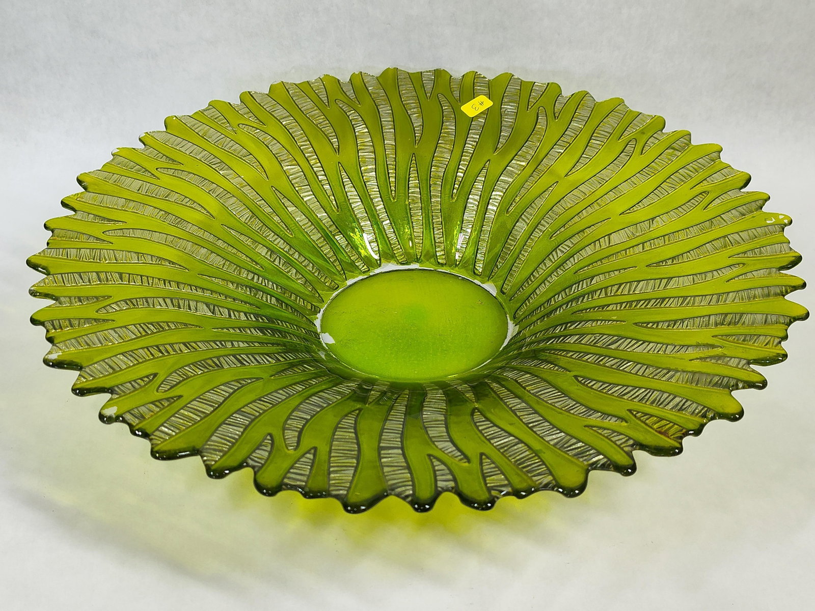 Lime Green Glass Bowl w/ Silvered Zebra Pattern: This large contemporary decorative centerpiece bowl is constructed from translucent lime green glass. The bowl displays a shallow, flared form that terminates in an organic, scalloped rim. A