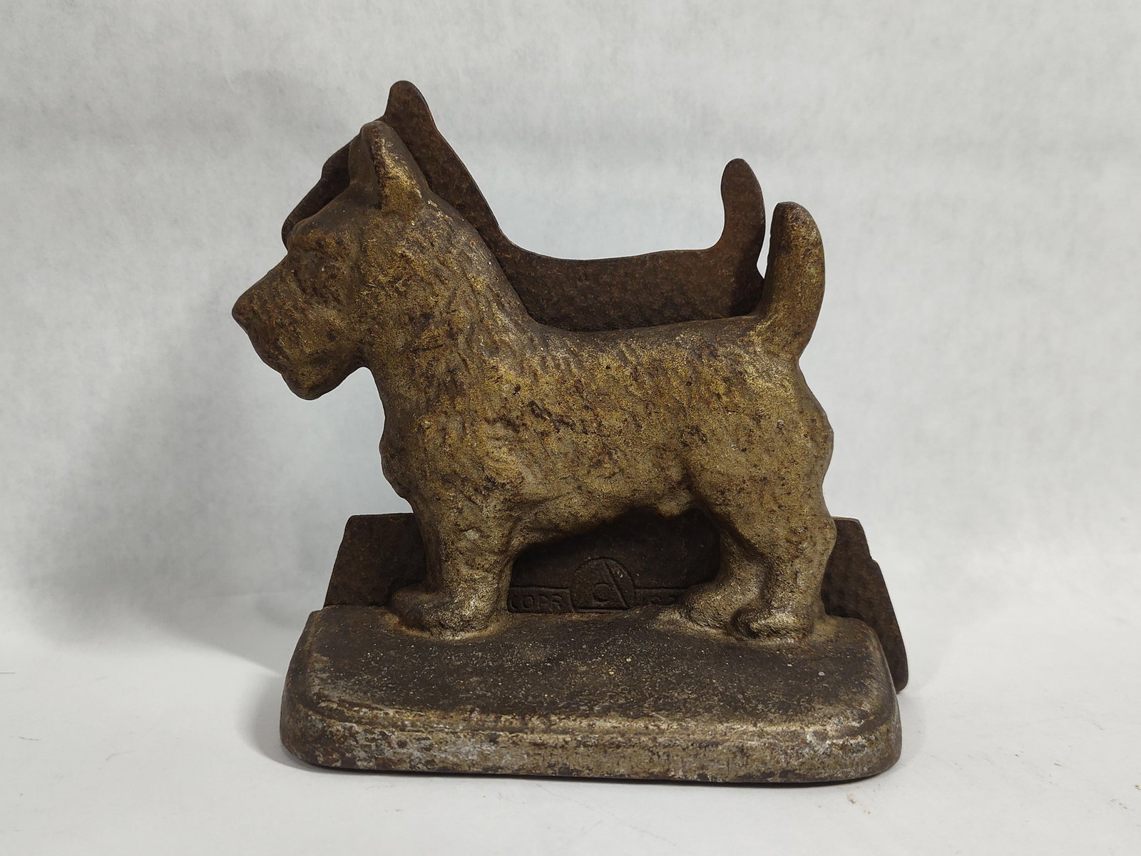 Pair Hubley Cast Iron Scottish Terrier Bookends: A pair of vintage cast iron bookends produced by the Hubley Manufacturing Company, modeled as standing Scottish Terriers. Each bookend features a Scottie dog in profile on a stepped rectangular base. 