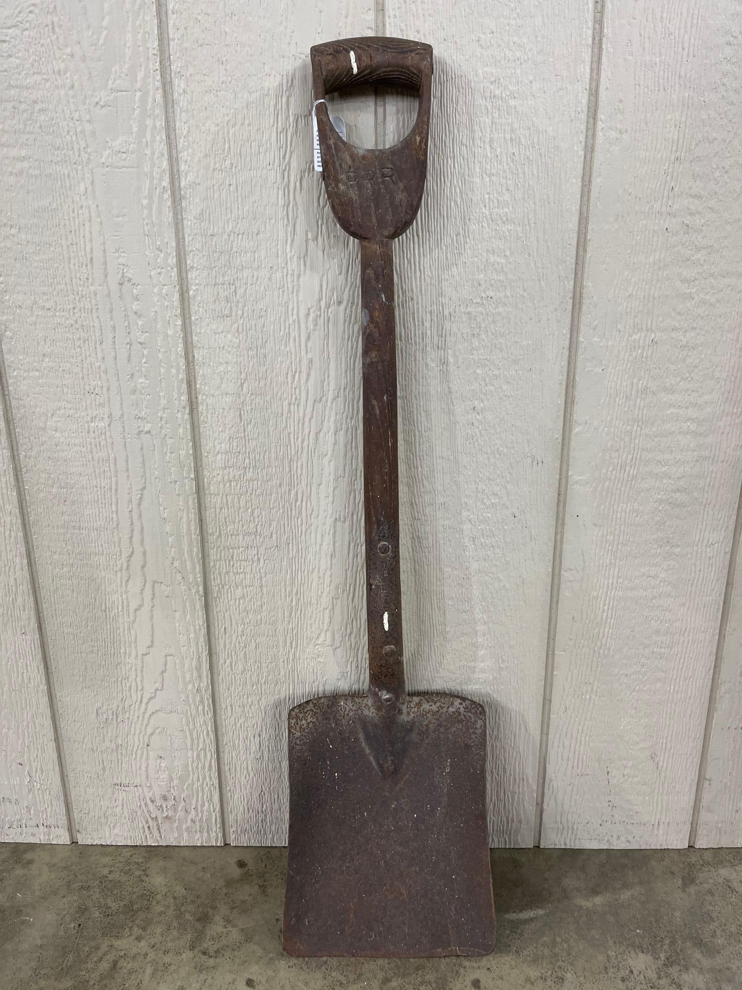 Pennsylvania Railroad Stamped D-Handle Coal Shovel: A vintage square-point coal shovel featuring a heavy-gauge metal blade and a wooden shaft. The handle is a carved D-grip style and is stamped with the initials PRR, identifying it as equipment from