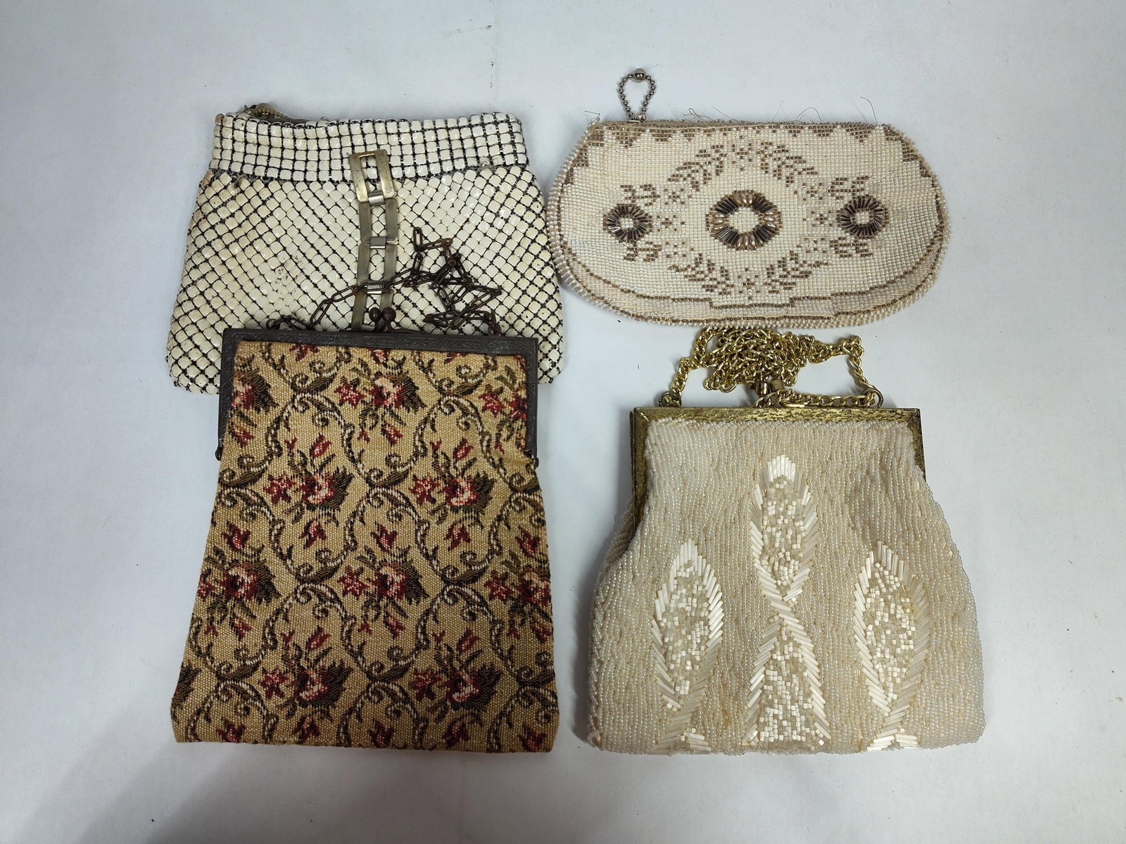 Vtg Beaded, Tapestry & Enameled Mesh Evening Bags: This collection includes several vintage accessories featuring a variety of styles and materials common to mid-20th-century fashion. Included is a white enameled metal mesh clutch accented with a