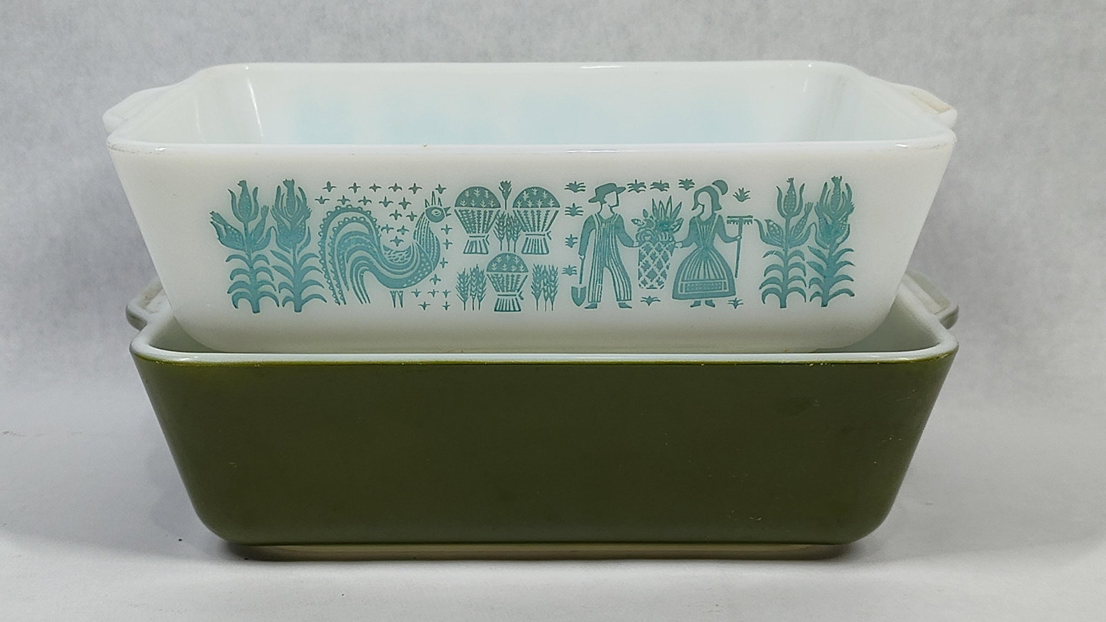 Pair Pyrex 503 Butterprint & Olive Green Dishes: A pair of vintage mid-century modern rectangular glass refrigerator dishes manufactured by Pyrex, both in the 1.5-quart size and designated as model number 503. Each dish is constructed of white opal