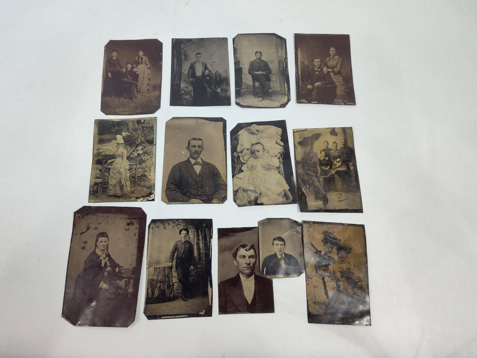 19th C. Tintype Studio Portraits: This collection features several original 19th-century tintypes, also known as ferrotypes, depicting a variety of Victorian-era sitters. The portraits are formal studio compositions and include