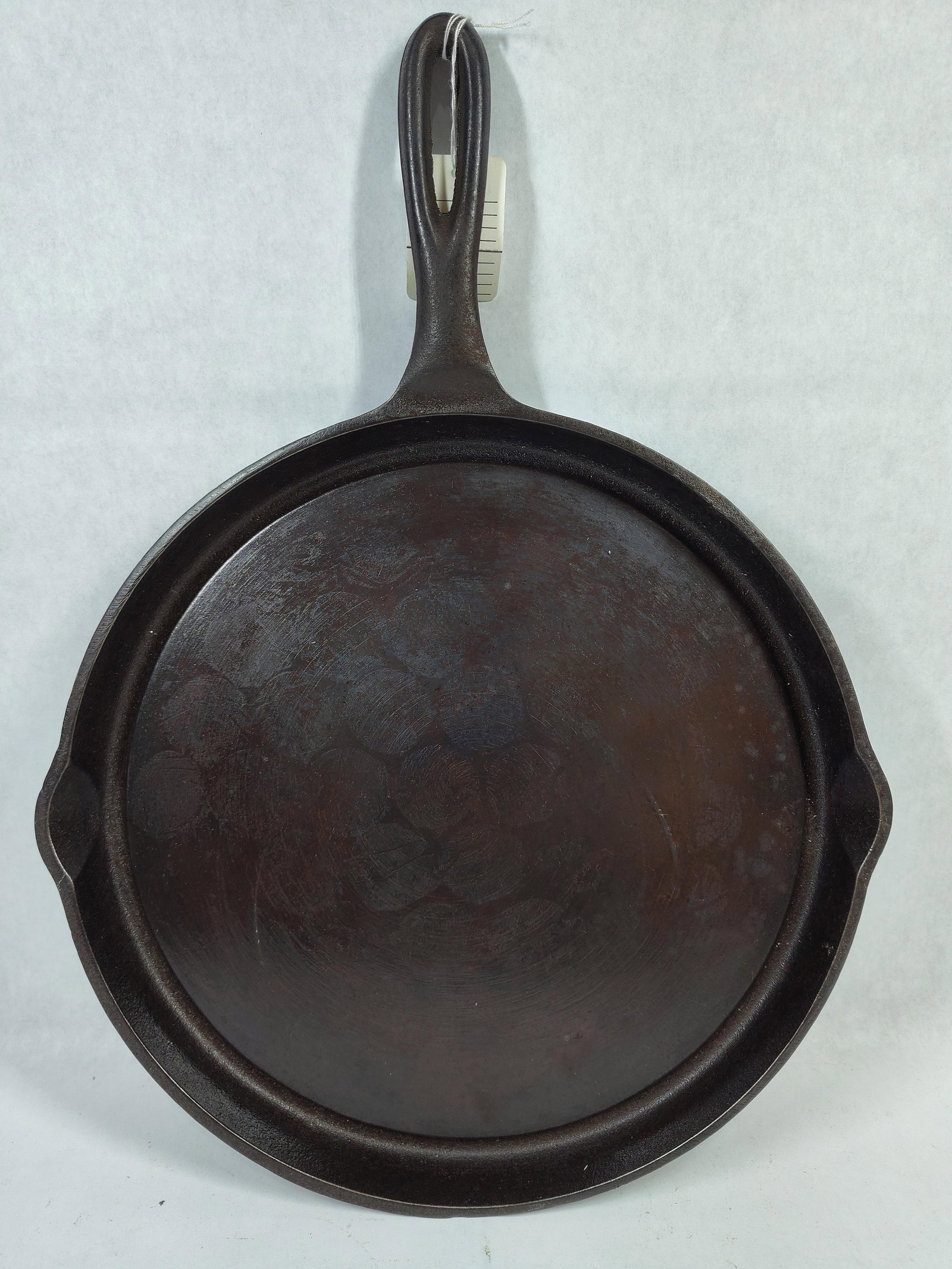 Wagner Ware Sidney Fat Free Fryer Griddle 1102H: This vintage circular cast iron griddle is a Wagner Ware Sidney -O- Fat Free Fryer, model number 1102H. The piece is constructed of cast iron and features a shallow rim with two small, integrated