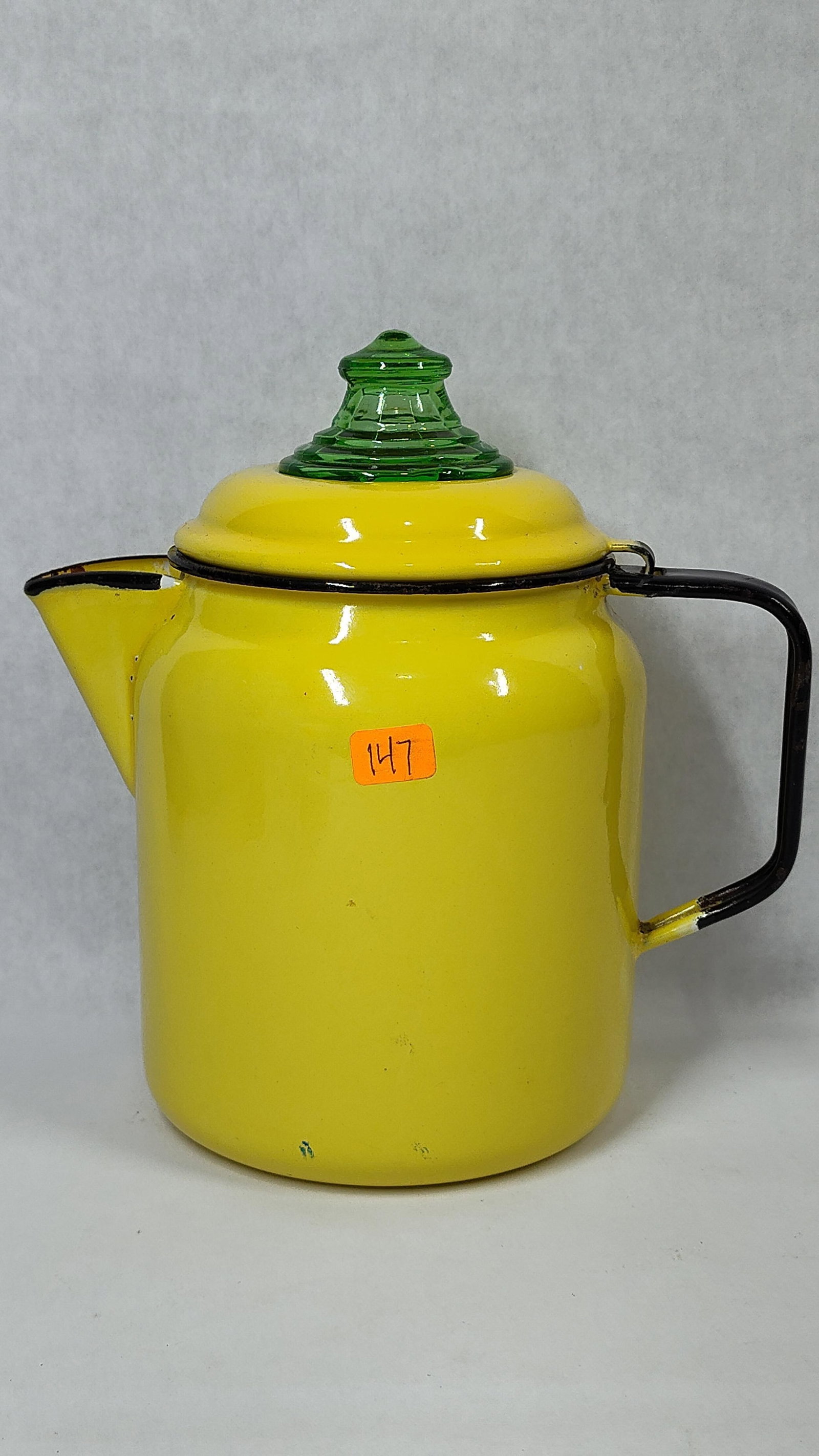 Mid-Century Yellow & Black Enamelware Percolator: A vintage stovetop coffee percolator featuring a bright yellow enamel-coated metal body and lid. The design is accented with contrasting black enameled trim on the handle, spout, and rim. The lid is