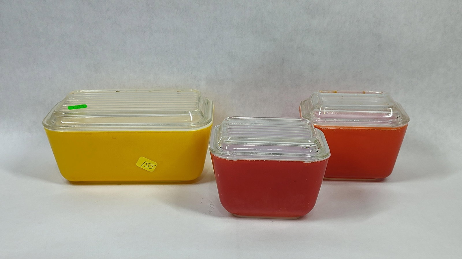 Pyrex Primary Colors Refrigerator Dishes w/ Lids: This lot consists of three vintage Pyrex refrigerator storage dishes, frequently referred to as fridgies, from the Primary Colors collection. The set features one large rectangular dish in yellow and 
