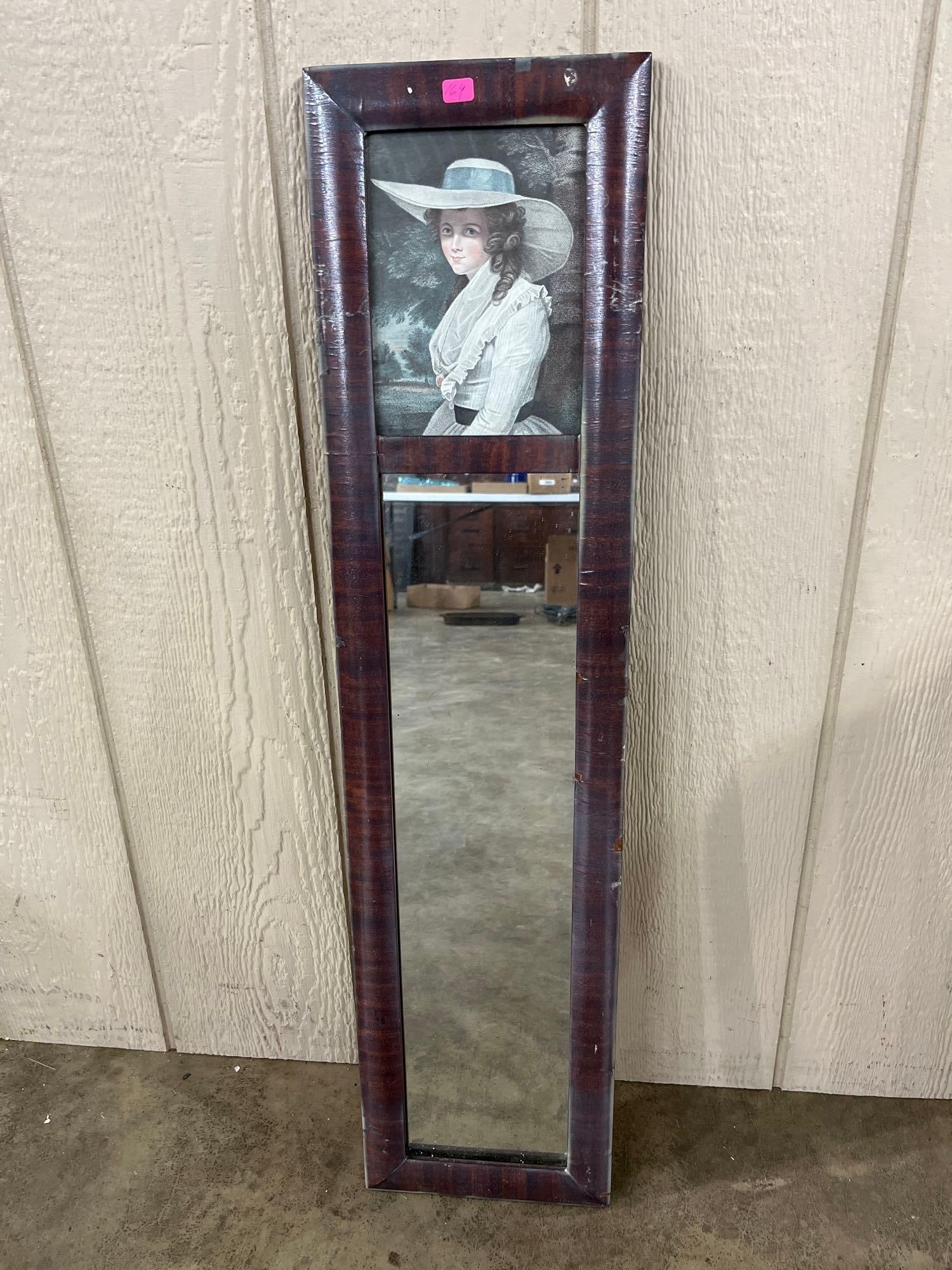 Federal Style Mahogany Mirror w/ Portrait Print: This wall mirror is designed in the Federal or Colonial Revival style and features a tall, narrow rectangular form. The frame is constructed of wood with a dark mahogany veneer that exhibits a