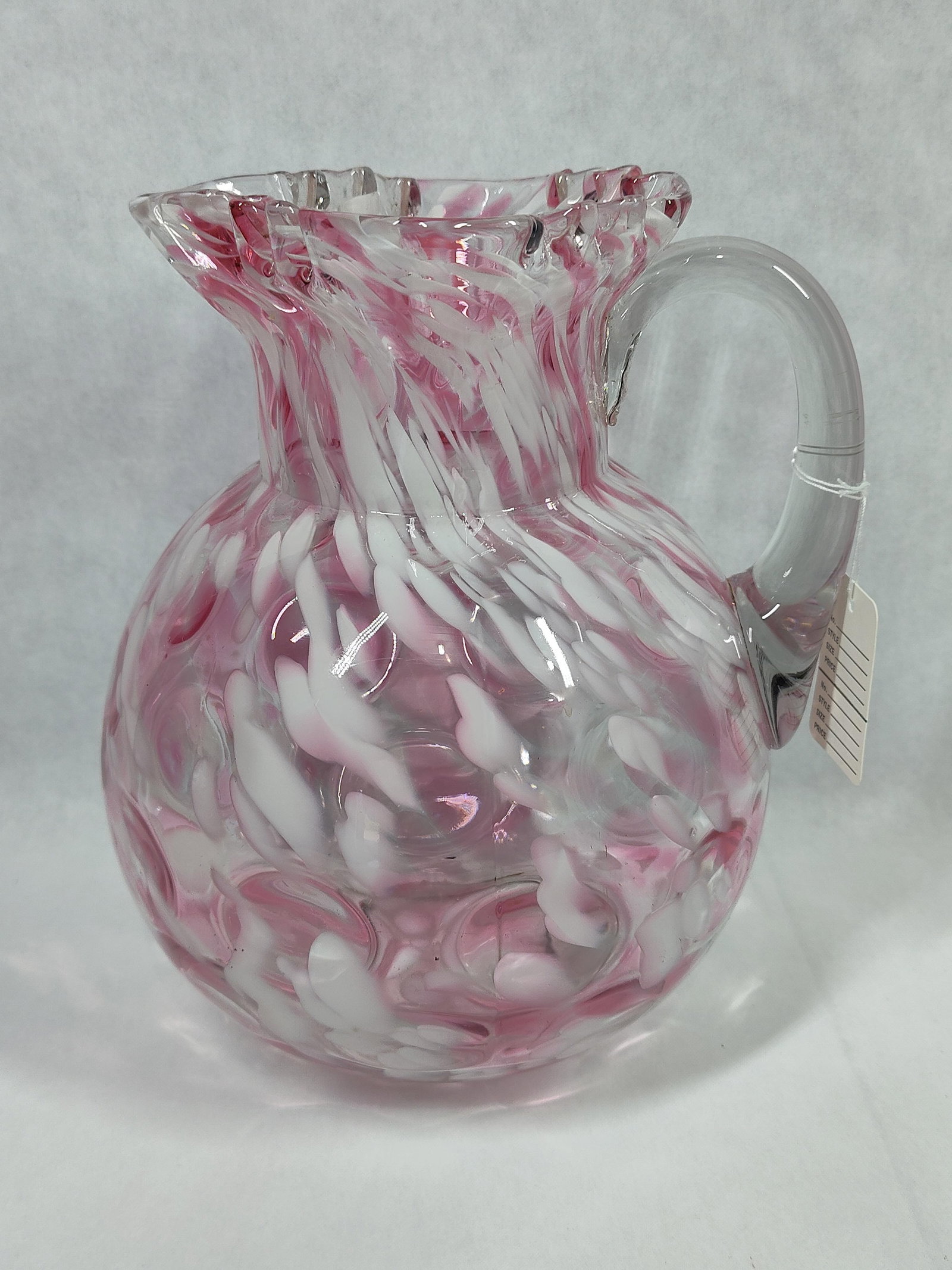 Pink & White Spatter Dot Optic Art Glass Pitcher: A hand-blown art glass pitcher characterized by a bulbous form and a dot optic or coinspot texture. The vessel features vibrant pink and opaque white spatter glass inclusions encased in a clear glass