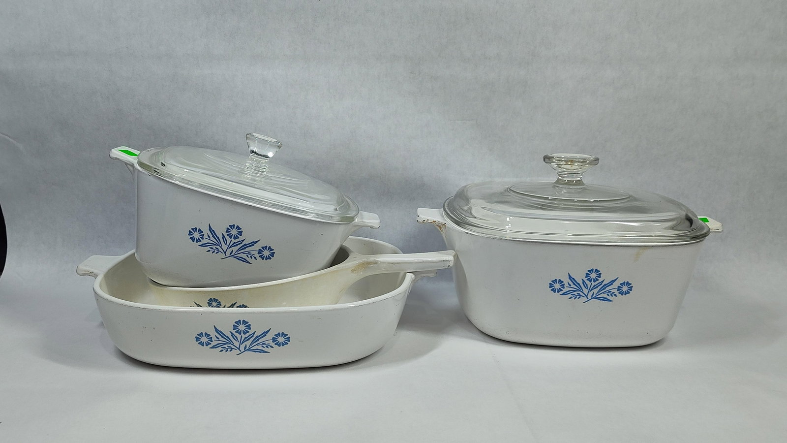 CorningWare Blue Cornflower Cookware: A collection of vintage CorningWare oven-to-table cookware in the Blue Cornflower pattern. The items are manufactured from white Pyroceram glass-ceramic and accompanied by clear tempered glass lids. T
