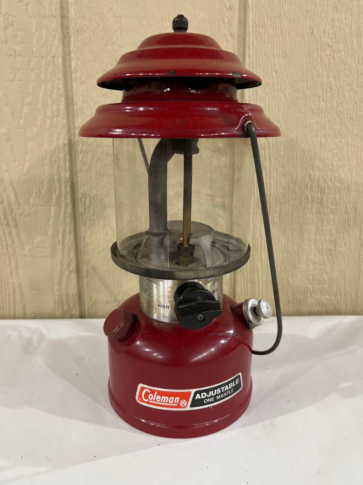 Coleman Model 286 One Mantle Lantern, July 1990: A vintage Coleman Model 286 adjustable single-mantle pressurized liquid fuel camping lantern. This unit features a red enameled steel ventilator and a red painted steel fount. The clear glass