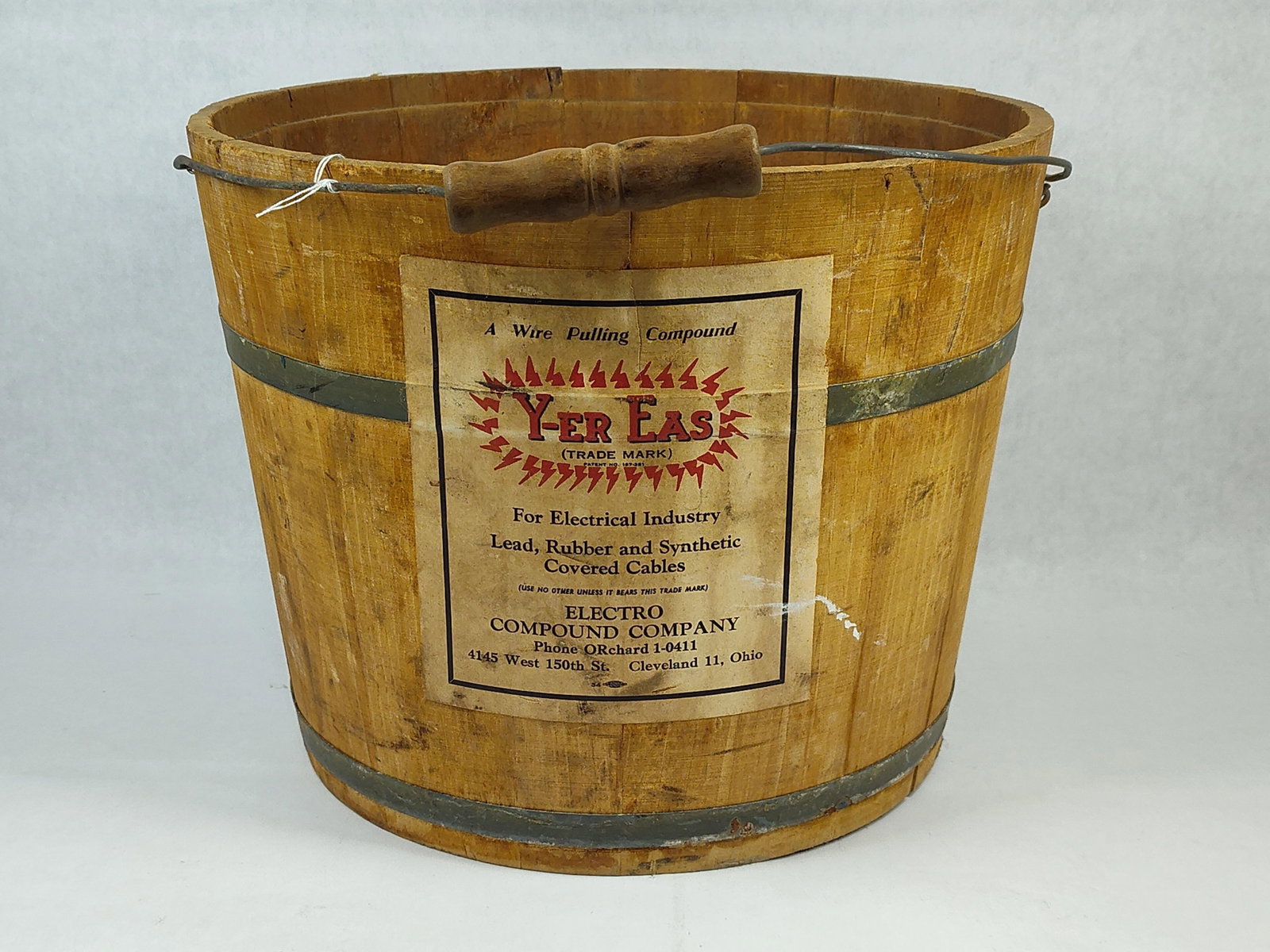 Electro Compound Co. Wire Pulling Wooden Bucket: This is a vintage industrial wooden bucket manufactured by the Electro Compound Company of Cleveland, Ohio. The vessel is constructed of wooden staves bound by two metal hoops. It features a wire bail