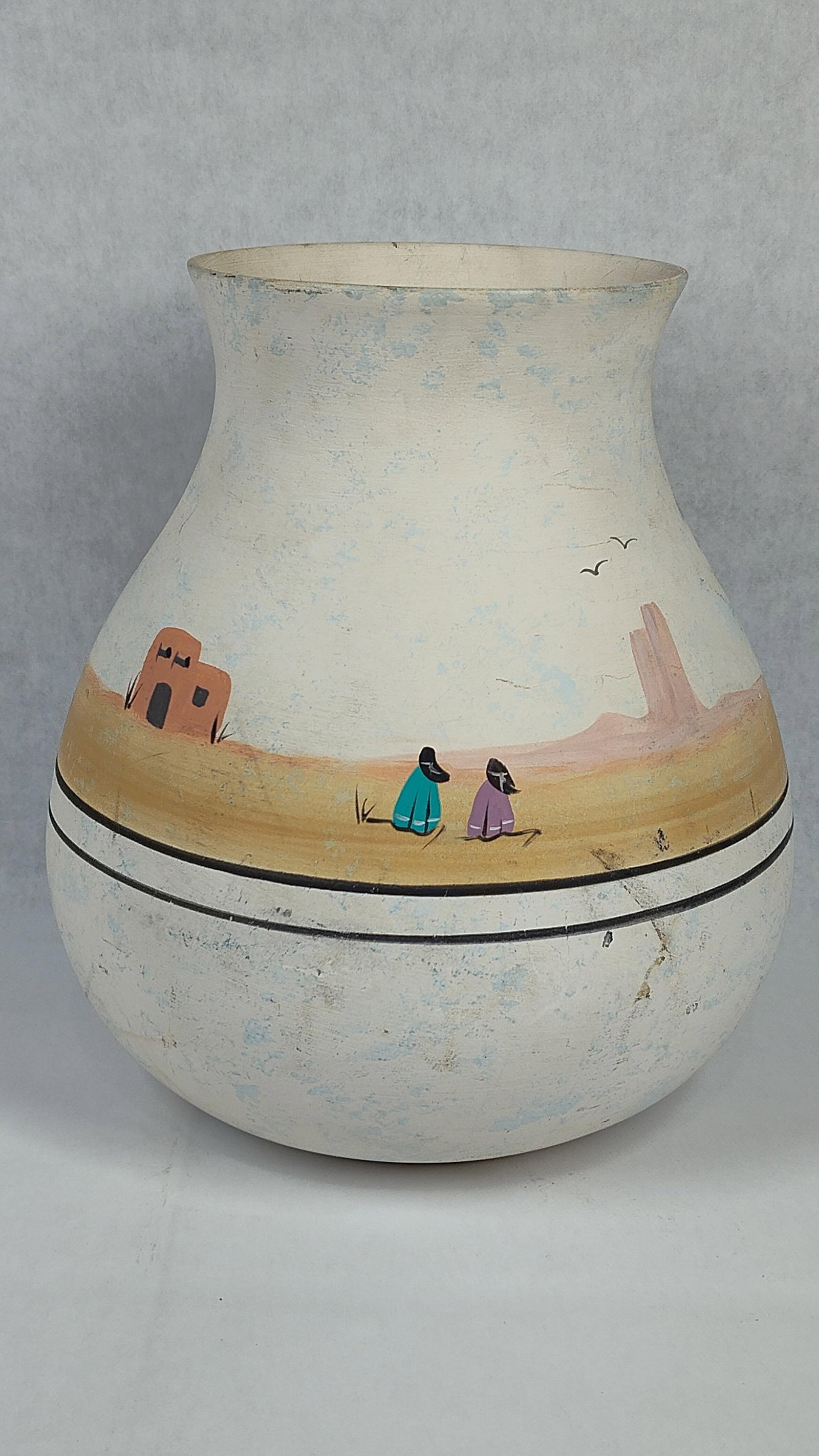 Southwestern Hand-Painted Ceramic Landscape Vase: This is a hand-painted earthenware ceramic vase featuring a Southwestern-style landscape motif. The vessel is constructed with a rounded, bulbous body tapering to a narrow neck and a flared rim. The