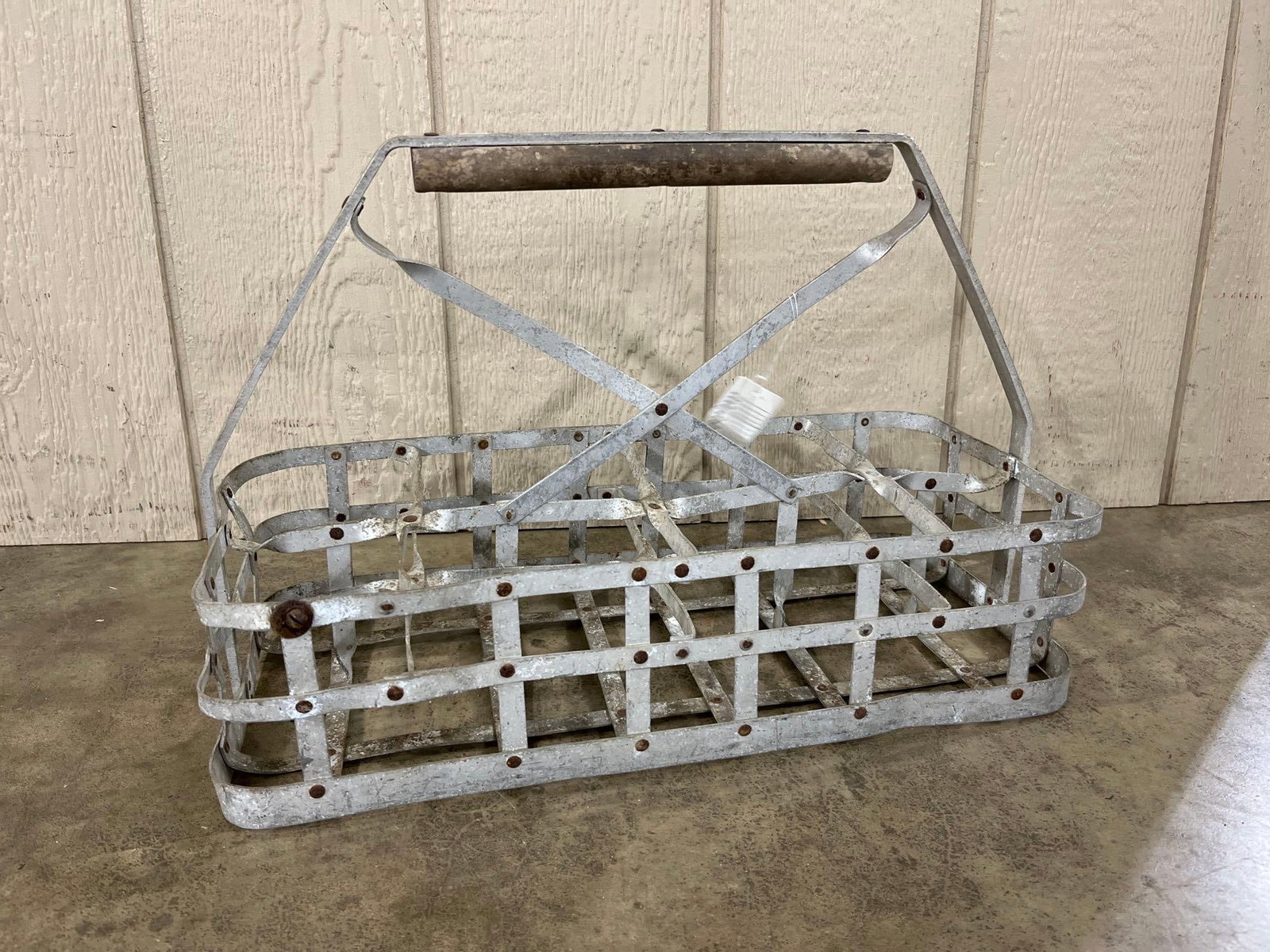 Vtg Galvanized 6-Compartment Milk Bottle Carrier: A vintage milk bottle carrier constructed from galvanized metal flat straps secured with rivets. The carrier is divided into six rectangular compartments in a two-by-three configuration, designed for