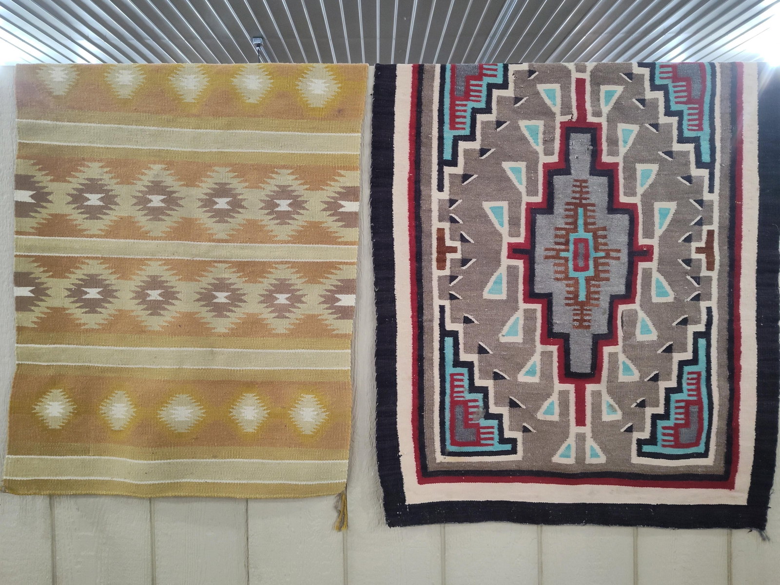 Two Navajo-Style Geometric Flatwoven Wool Rugs: This lot contains two Navajo-style flatwoven rugs constructed from wool. The first rug, positioned on the left, features a banded geometric composition with horizontal rows of repeating serrated