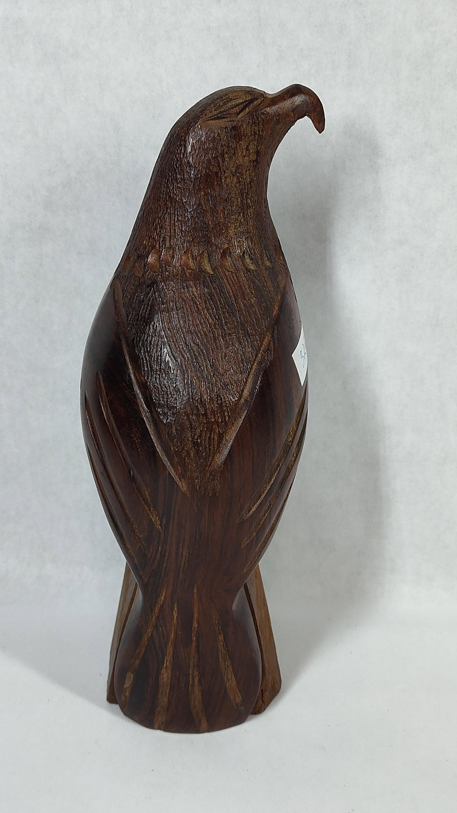 Hand-Carved Mexican Ironwood Eagle Sculpture: A hand-carved wooden sculpture of an eagle, attributed to the Seri craftsmen of Sonora, Mexico. The piece is fashioned from dense, dark ironwood with a polished finish that highlights the natural