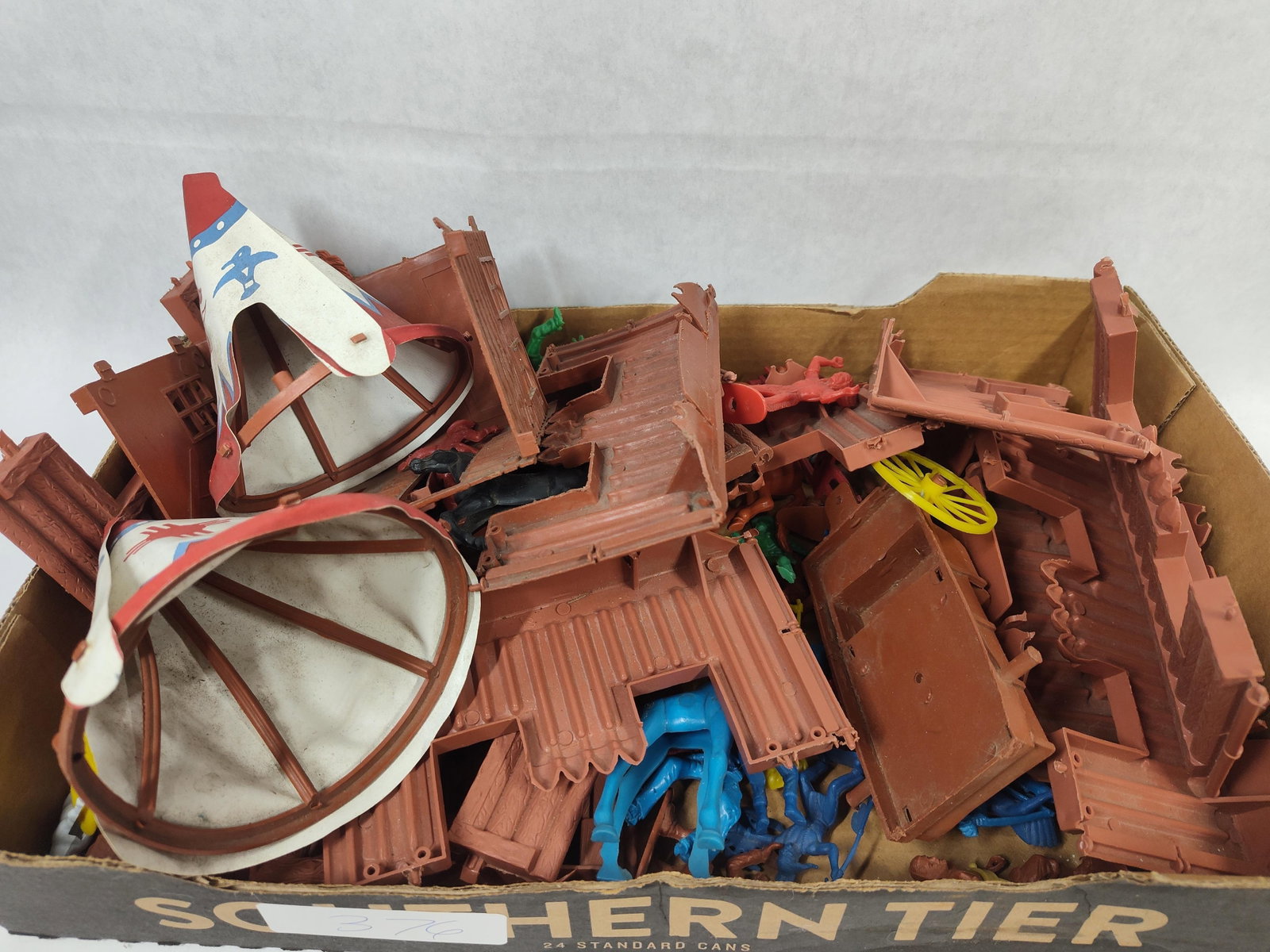 Attributed Louis Marx & Co. Western Playset Pieces: An assortment of vintage Western-themed plastic playset components, attributed to Louis Marx and Co. and likely originating from a Fort Apache or similar frontier outpost set. The lot consists of