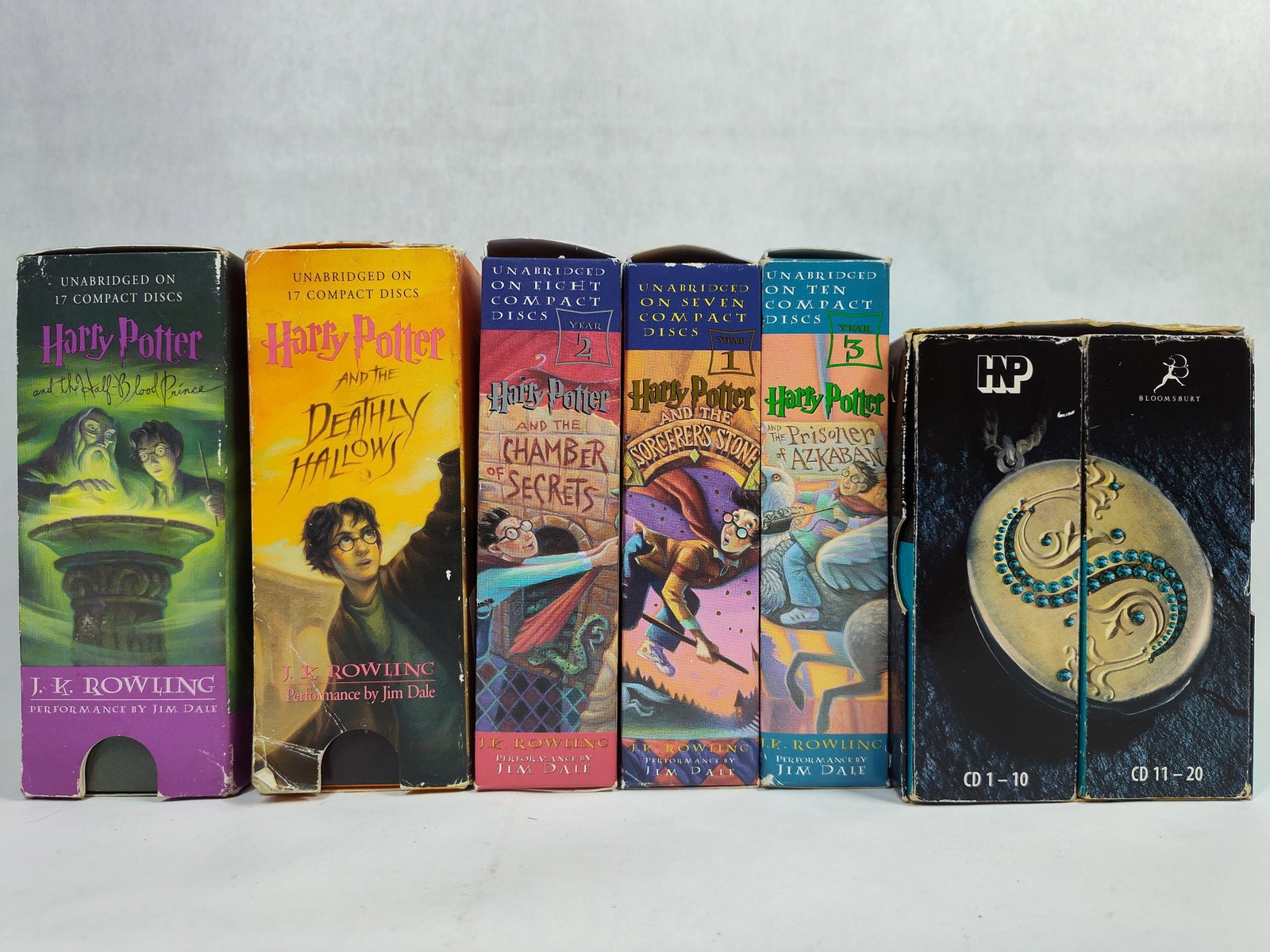 Rowling, J.K. Harry Potter Unabridged CD Sets: A collection of unabridged Harry Potter audiobook sets on compact disc featuring various titles from the series. The group includes multiple sets with narration by Jim Dale for the United States editi
