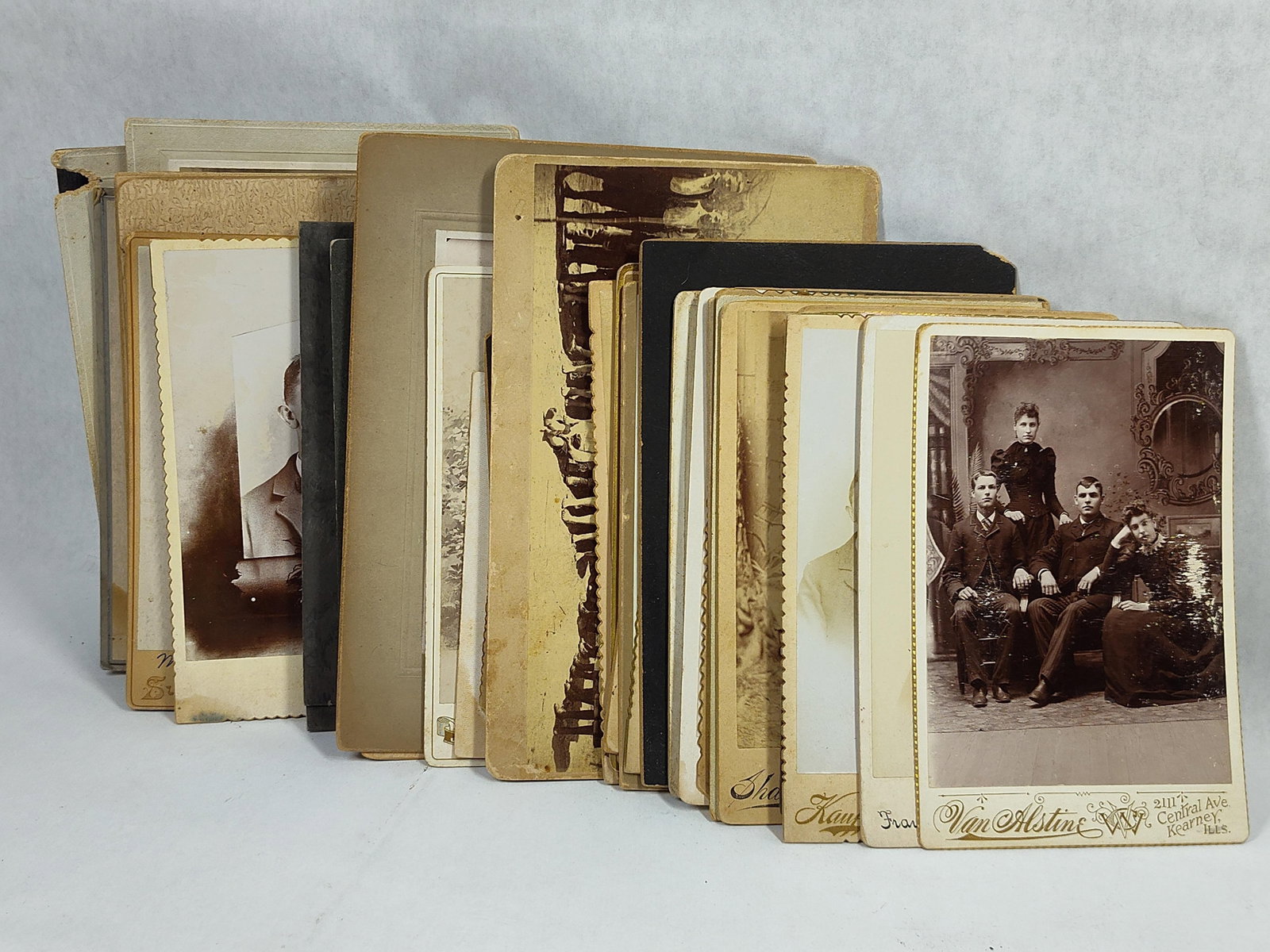 A Collection of Late 19th and Early 20th Century Studio Portrait Cabinet Cards: This collection consists of antique studio portrait photographs, primarily in the cabinet card format, dating from the late 19th to the early 20th century. The photographs depict various subjects