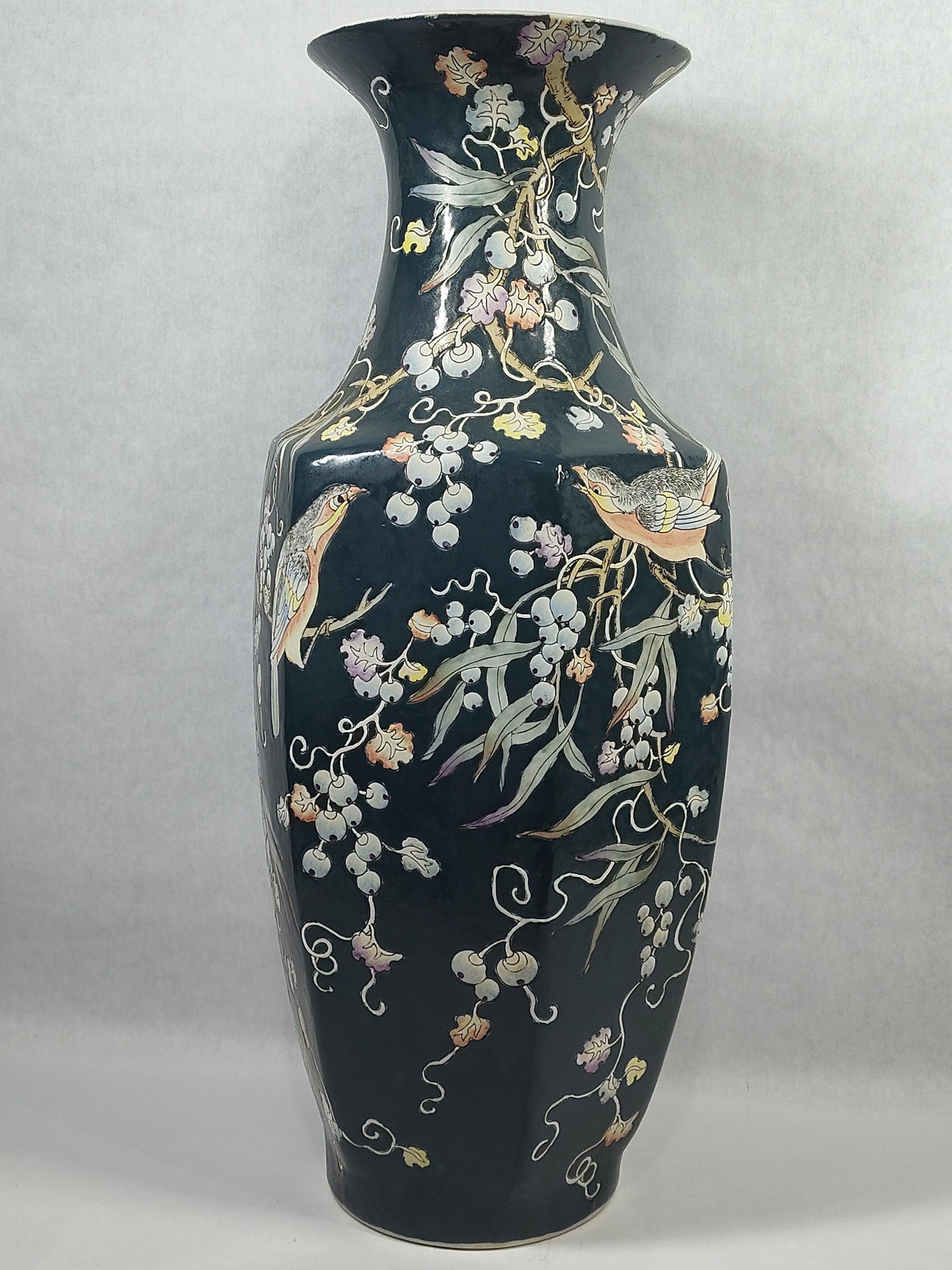 Faceted Octagonal Chinese Famille Noire Style Vase: A large, faceted octagonal baluster-form ceramic vase featuring a short neck and a widely flared trumpet rim. The exterior is decorated with a continuous scene of songbirds and botanical motifs,