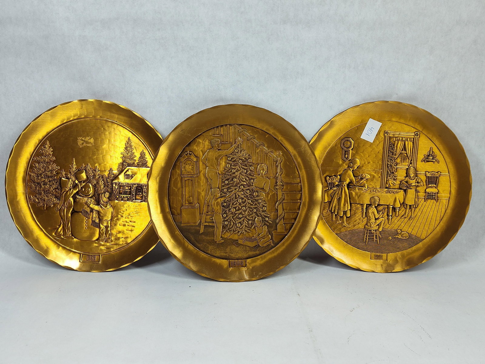 Wendell August Forge Trio Bronze Christmas Plates: A trio of solid bronze commemorative Christmas plates produced by the Wendell August Forge of Grove City, Pennsylvania. Each plate is hand-forged with a characteristic hammered or planished texture