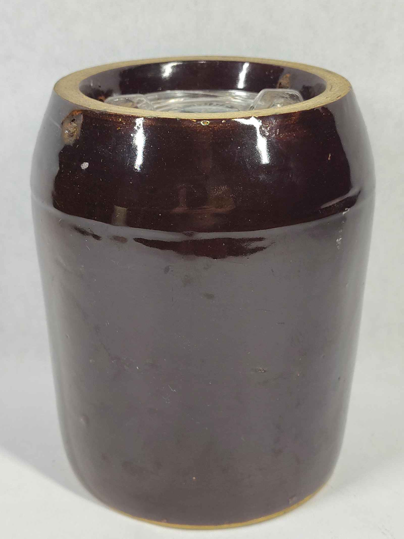 Brown Glazed Stoneware Canning Jar w/ Glass Lid: A small stoneware canning jar with a cylindrical body and tapered shoulder, finished in a dark brown Albany-type slip glaze. The vessel features an interior recessed rim to hold the accompanying circu