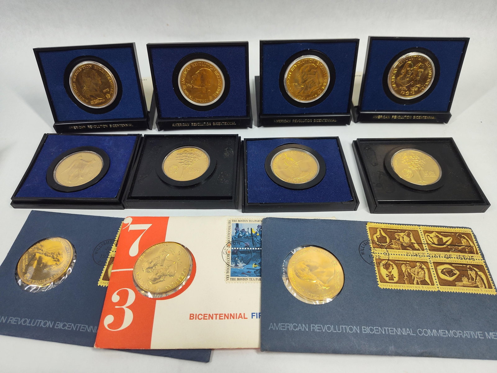 US American Revolution Bicentennial Medals: A collection of official US Mint American Revolution Bicentennial commemorative medals struck between 1972 and 1976. This group consists of gold-colored medals, likely gold-plated bronze, presented