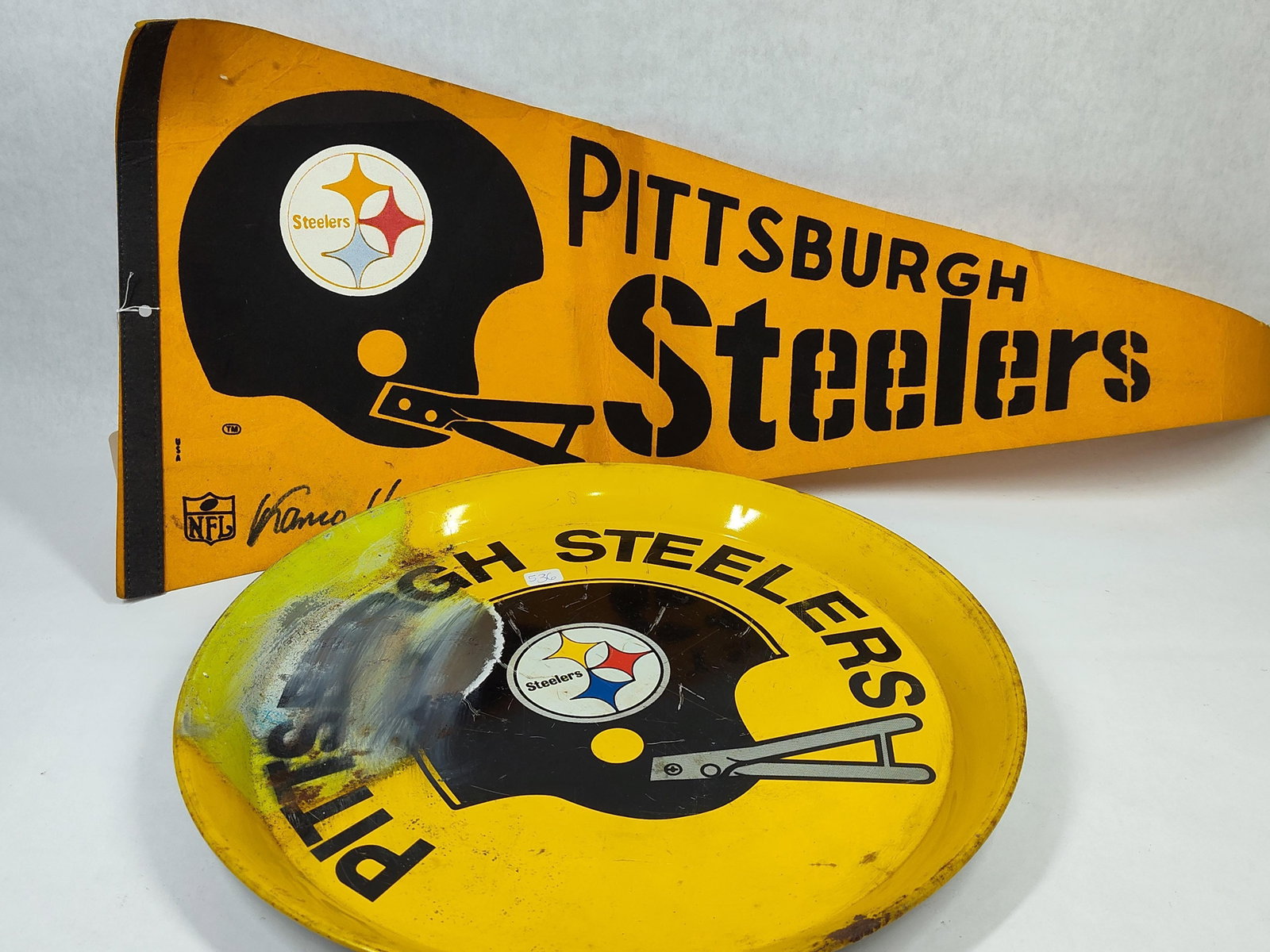 Pair Vtg Steelers & Franco Harris Signed Pennant: This lot features two vintage Pittsburgh Steelers memorabilia items. The first is a yellow felt pennant featuring black screen-printed graphics. The design includes a football helmet with the team's