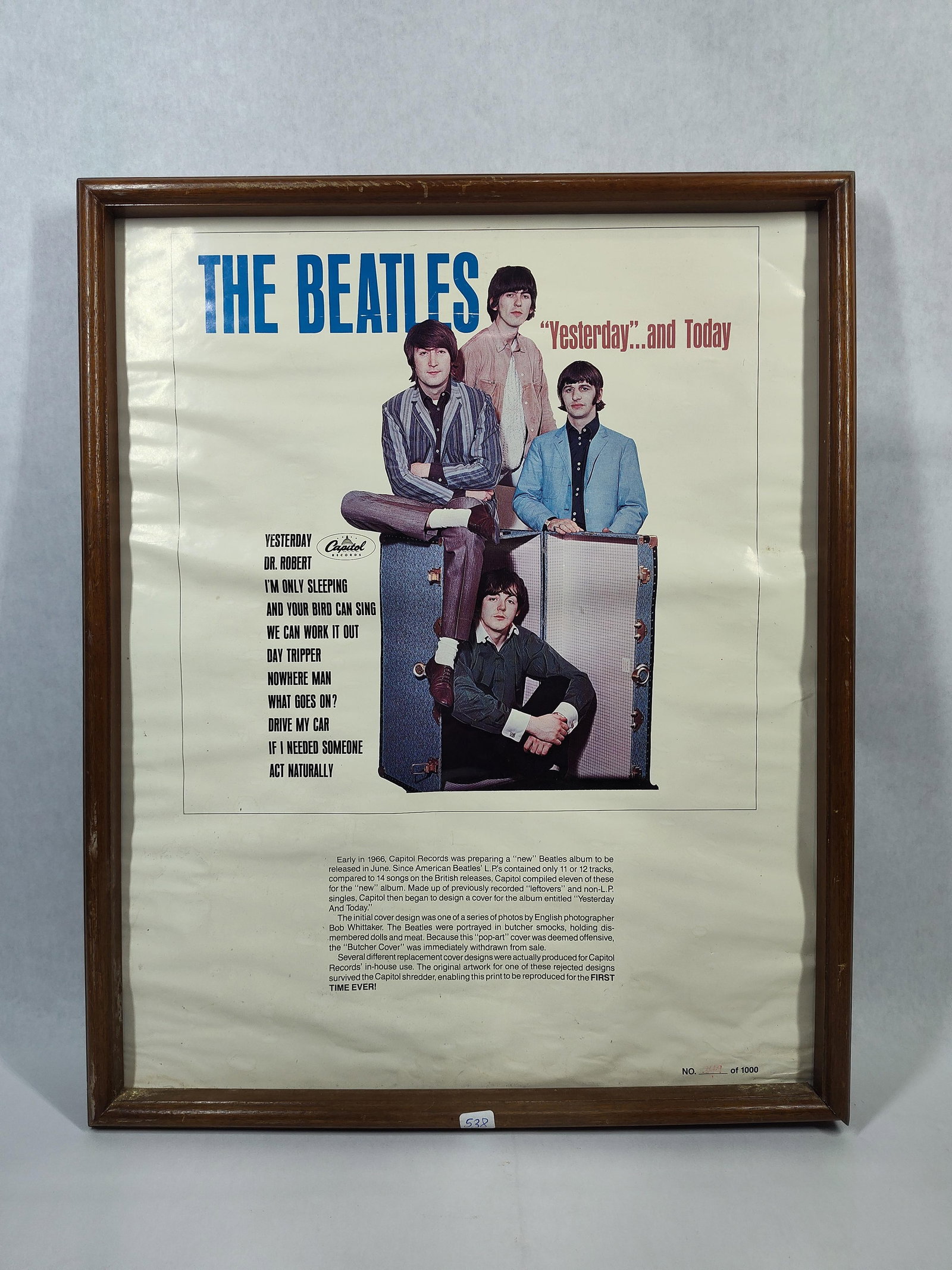 Beatles Yesterday & Today Trunk Cover Poster: Framed commemorative reproduction poster featuring the alternate trunk cover artwork for the 1966 Capitol Records album Yesterday... and Today. The central image depicts John Lennon, George Harrison,