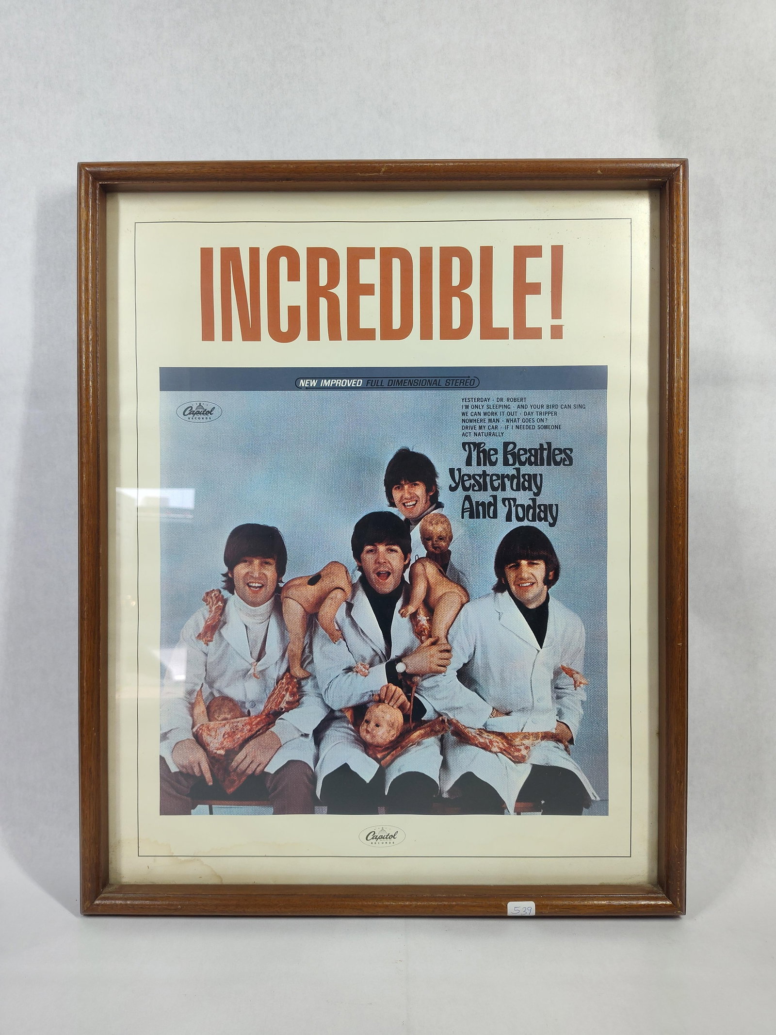 The Beatles Yesterday & Today Butcher Cover Poster: Framed promotional trade advertisement poster for the 1966 Capitol Records album Yesterday and Today by The Beatles. The poster features the controversial Butcher cover photograph captured by Robert