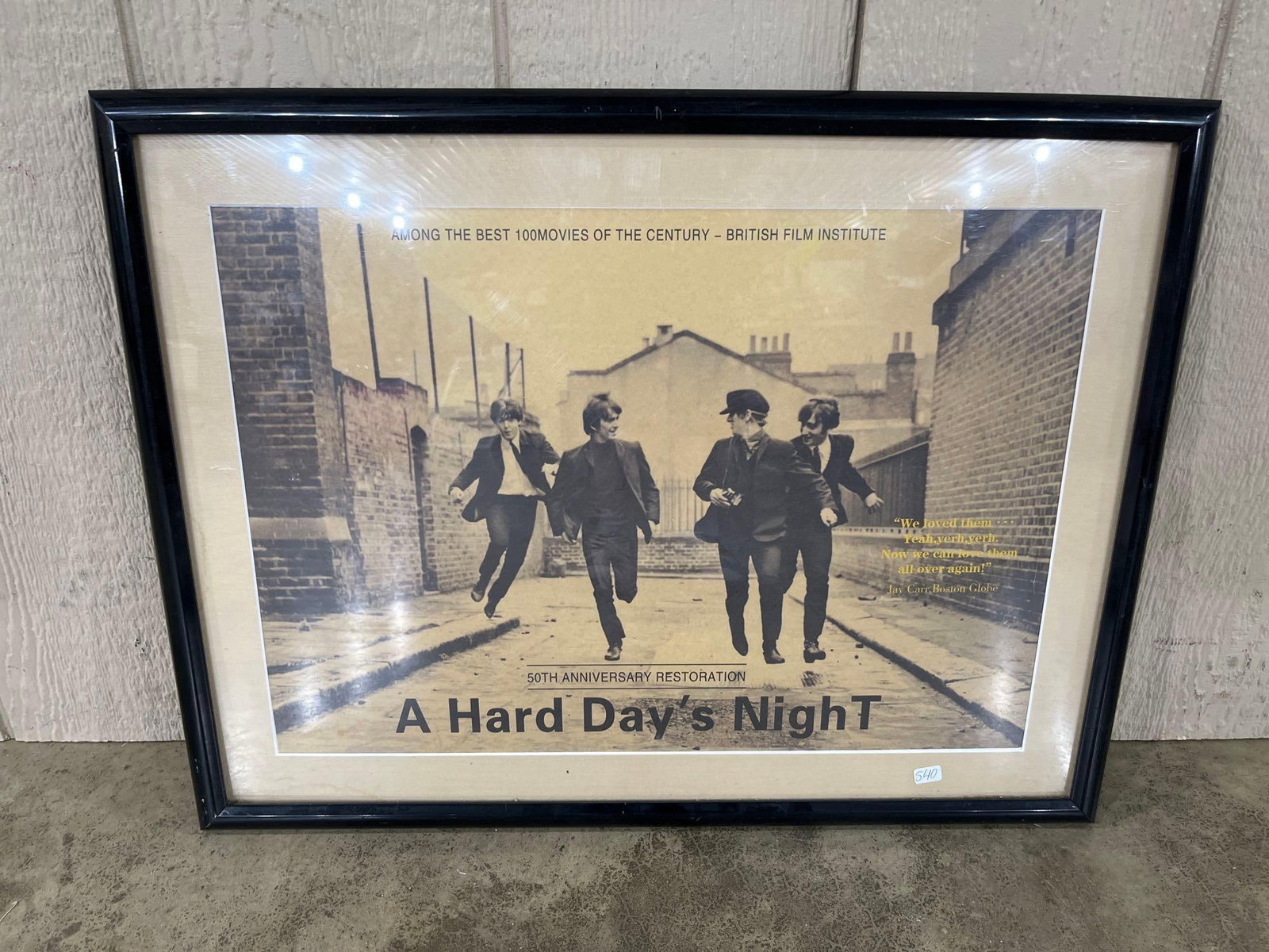 Beatles A Hard Day's Night 50th Anniversary Poster: This framed promotional poster was produced for the 2014 50th anniversary restoration of the 1964 motion picture A Hard Day's Night starring the Beatles. The poster features a sepia-toned photograph